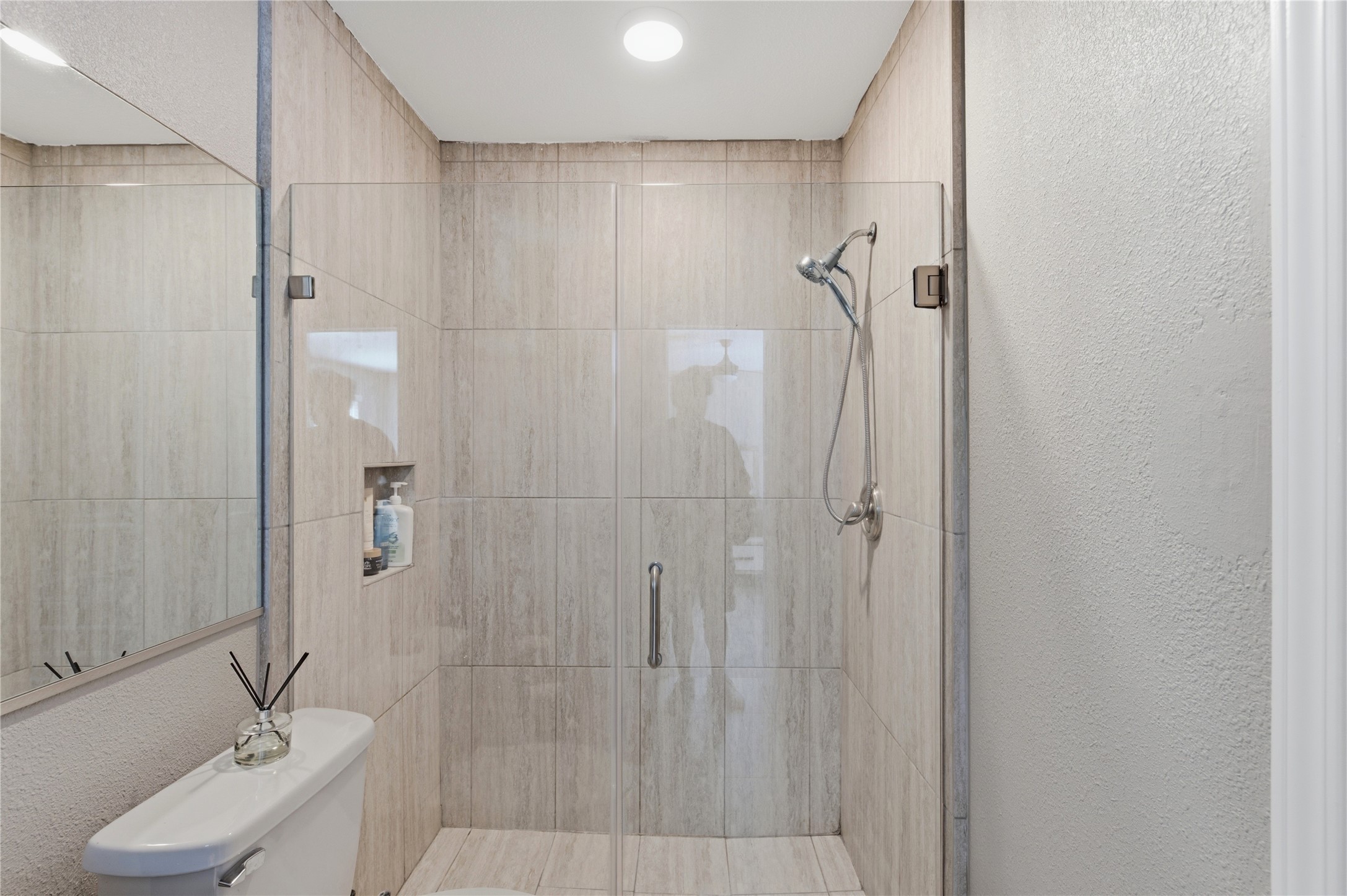 Ensuite primary bath featuring a frameless glass walk-in shower.