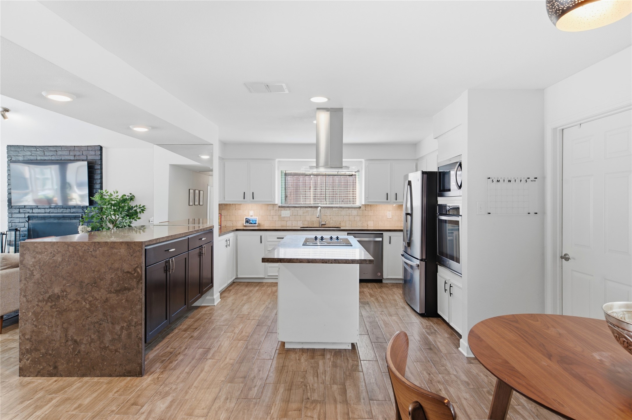 Stainless steel appliances and an island featuring an electric cooktop with hood make cooking a breeze! Stainless steel appliances and an island featuring an electric cooktop with hood make cooking a breeze!