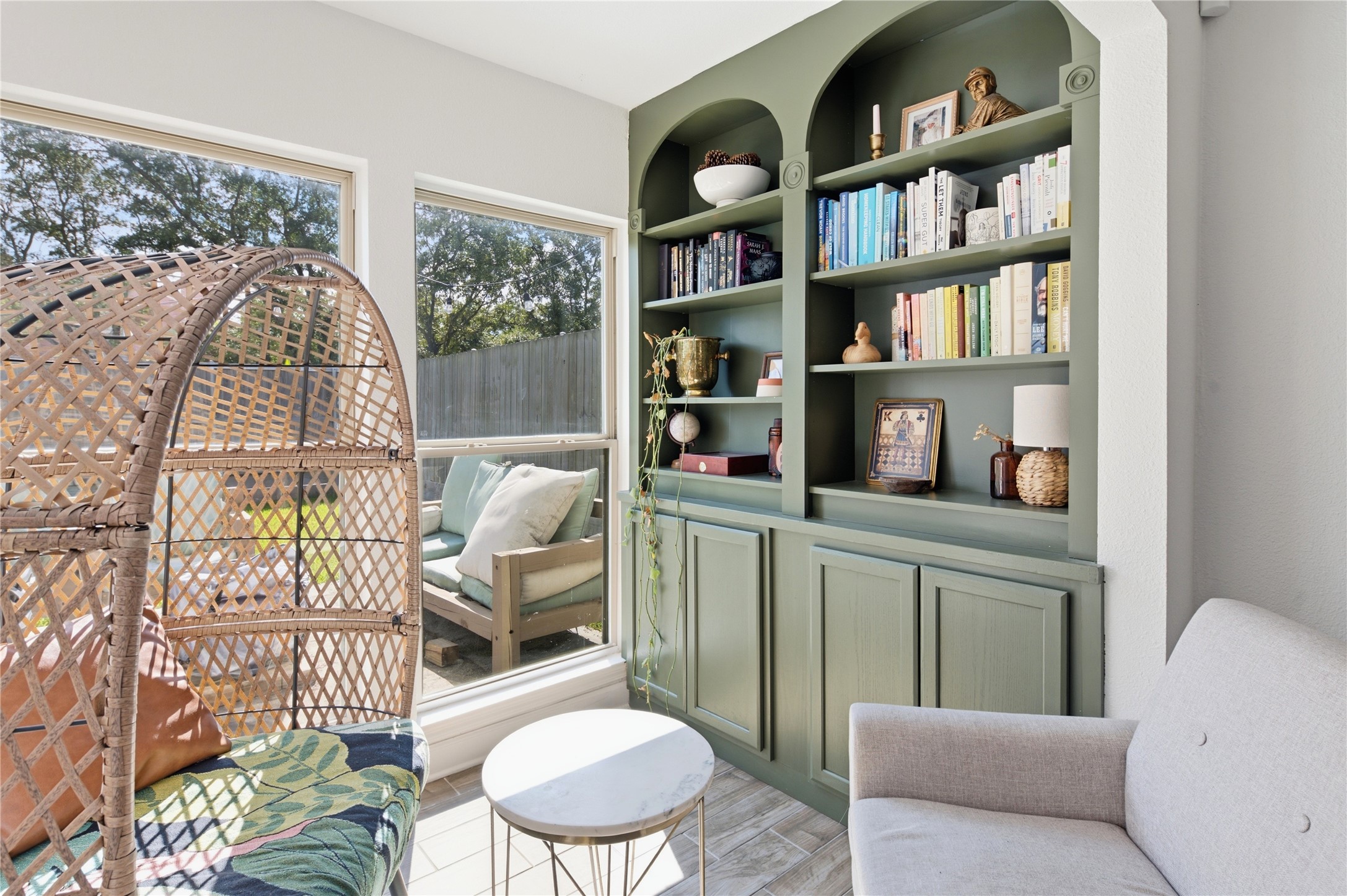 Versatile sunroom or flex space directly off the main living area with beautiful built-in shelving.