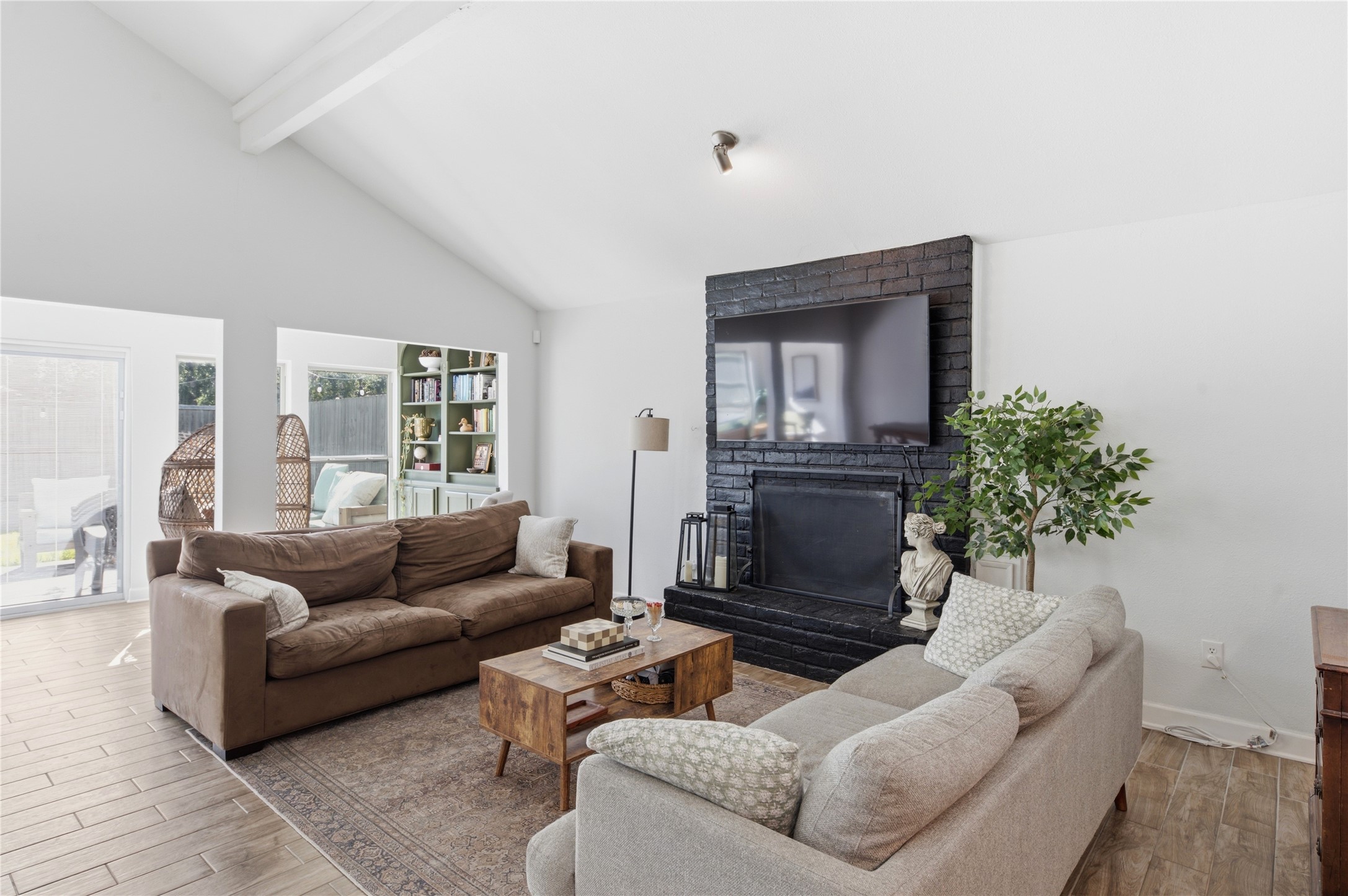 Spacious living room centered around a cozy fireplace.