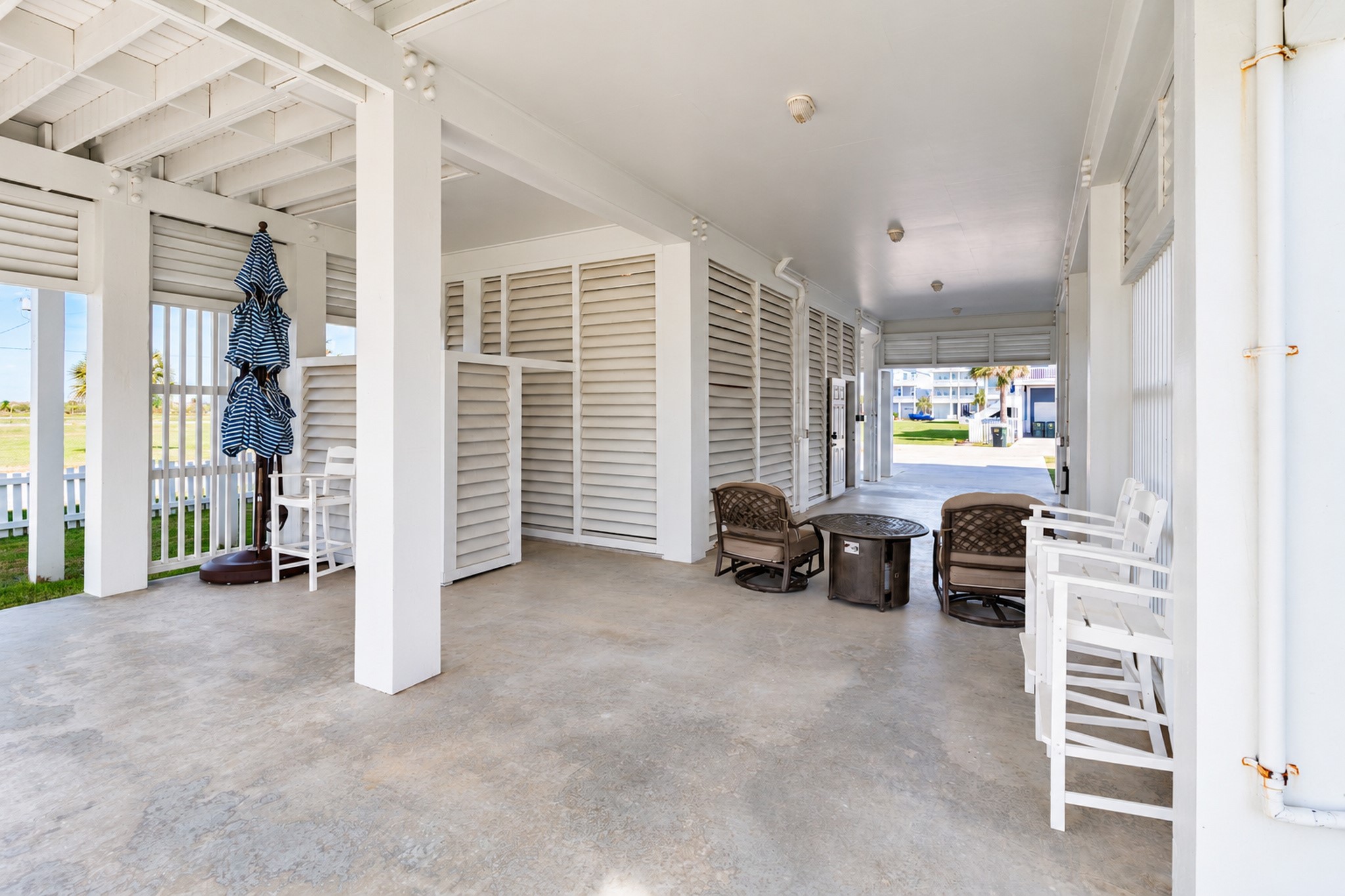 Downstairs patios space includes covered parking, outdoor shower, enclosed garage space and enough room to still entertain guest.