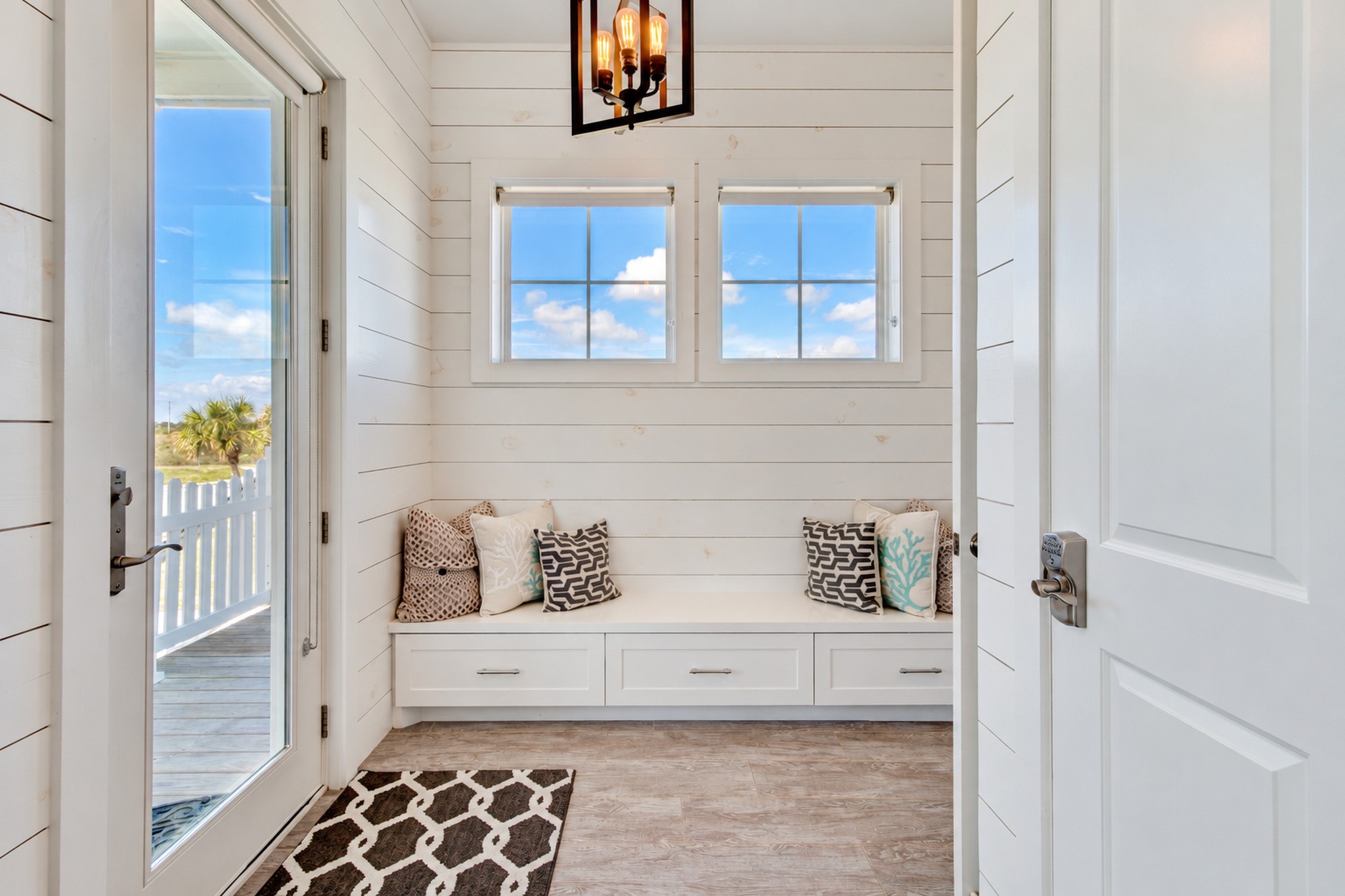 When you enter the home from the west deck you enter into a sitting room. This area has shiplap accent walls, 1/2 bath and built-in storage.