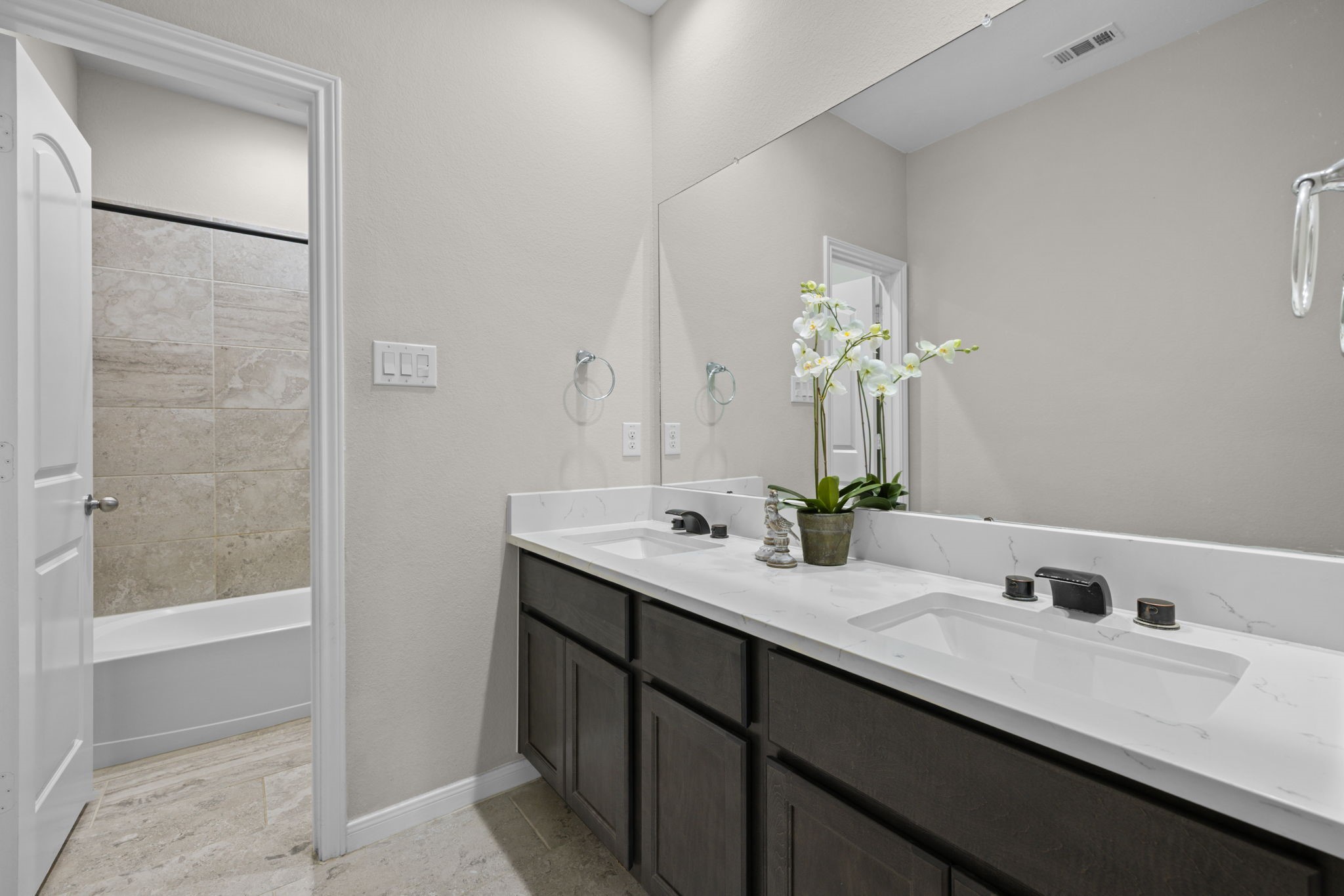 The hall bath has double sinks and separate wet area