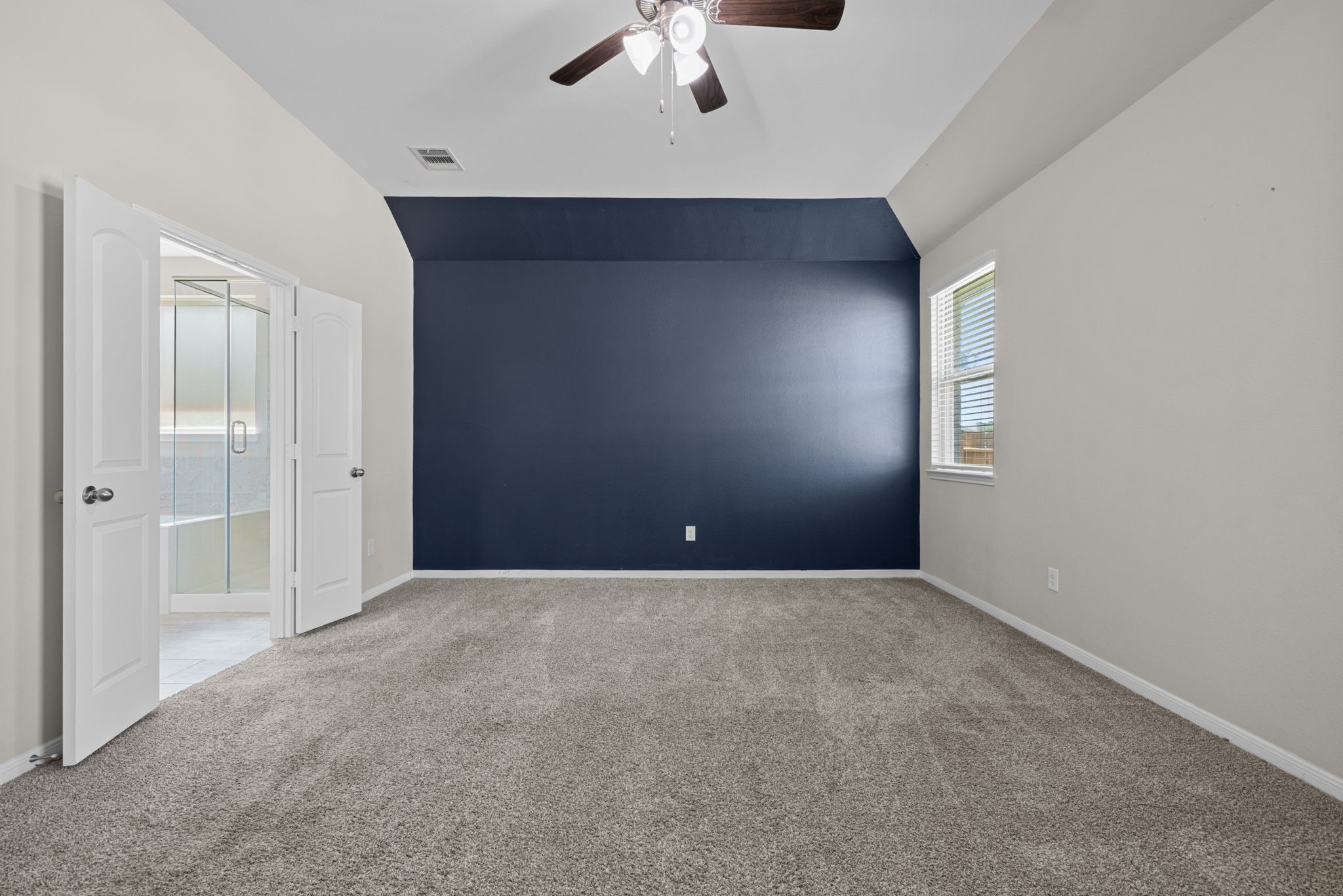 The primary is at the back of the home and split in this plan for ultimate privacy