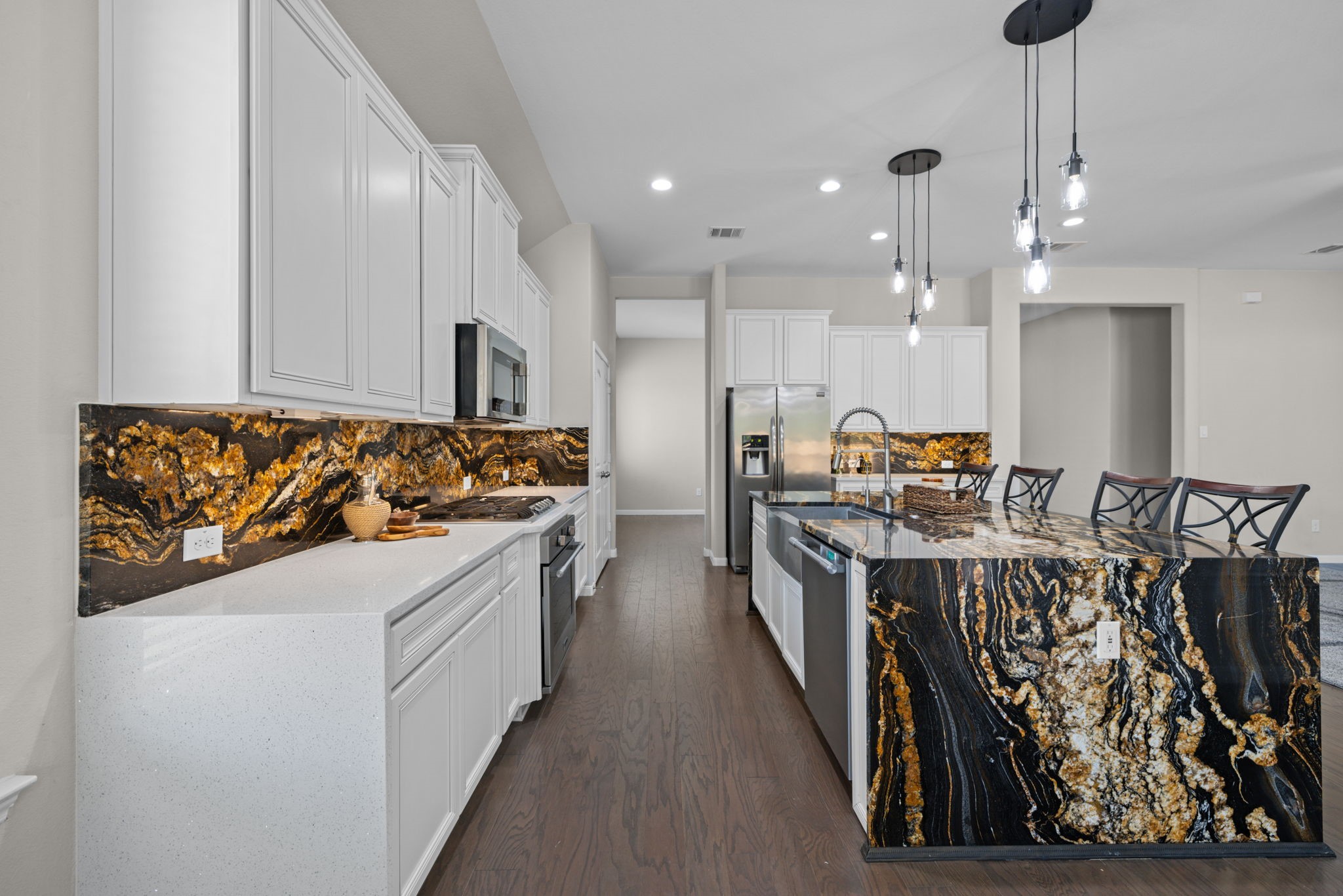 The stainless appliances include gas cook top and stainless farm house sink