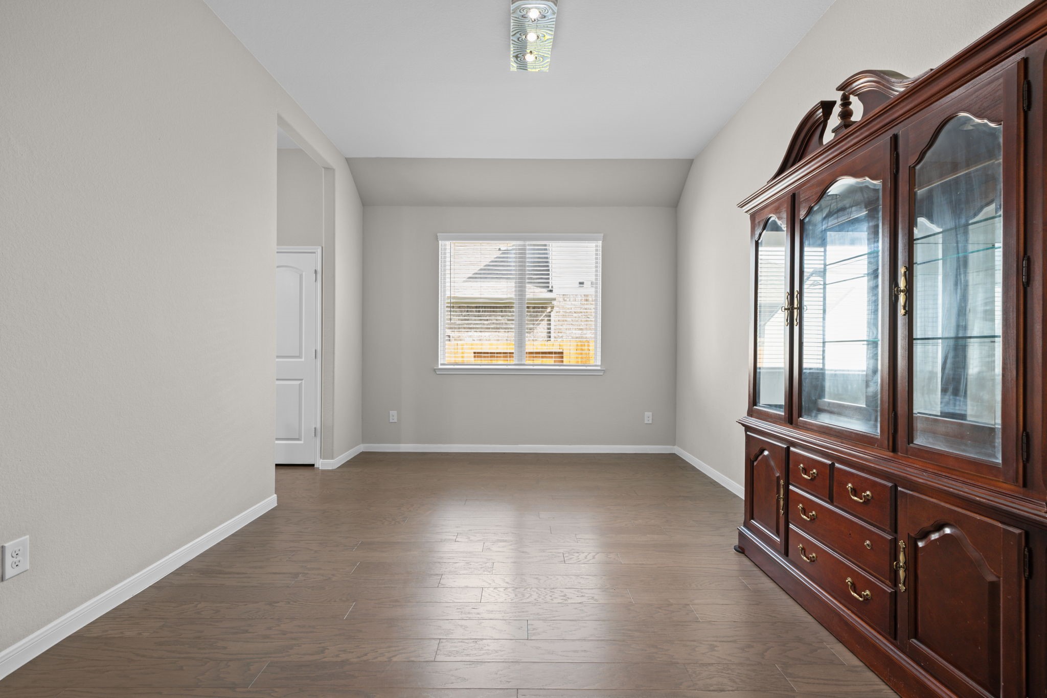 The formal dining area has windows for nice lighting and the wood floors carry through here