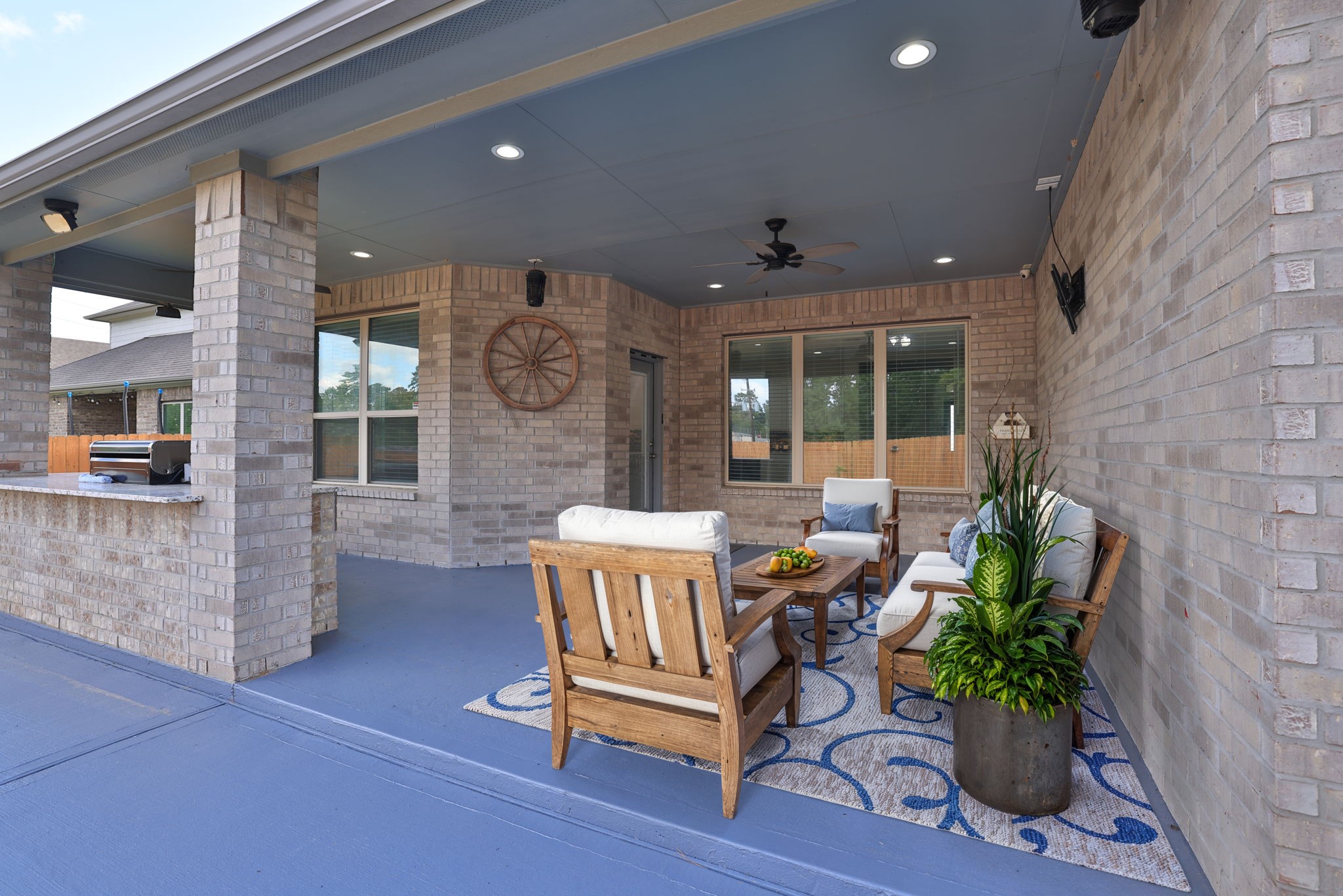 *virtually staged* You'll truly enjoy this extended covered patio with ceiling fan and recently painted concrete floor.