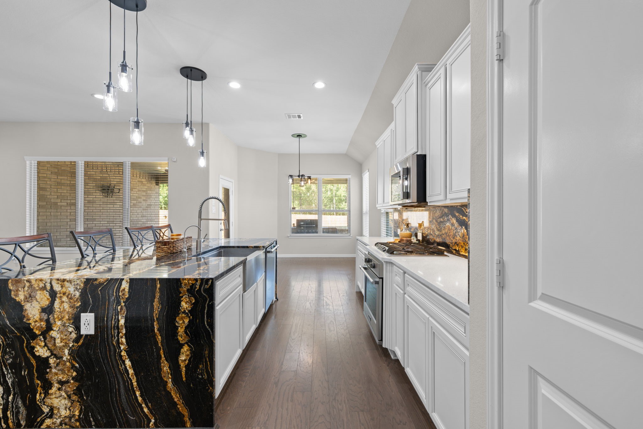 The breakfast area at the other end is another dining area or gathering space and leads out to the patio