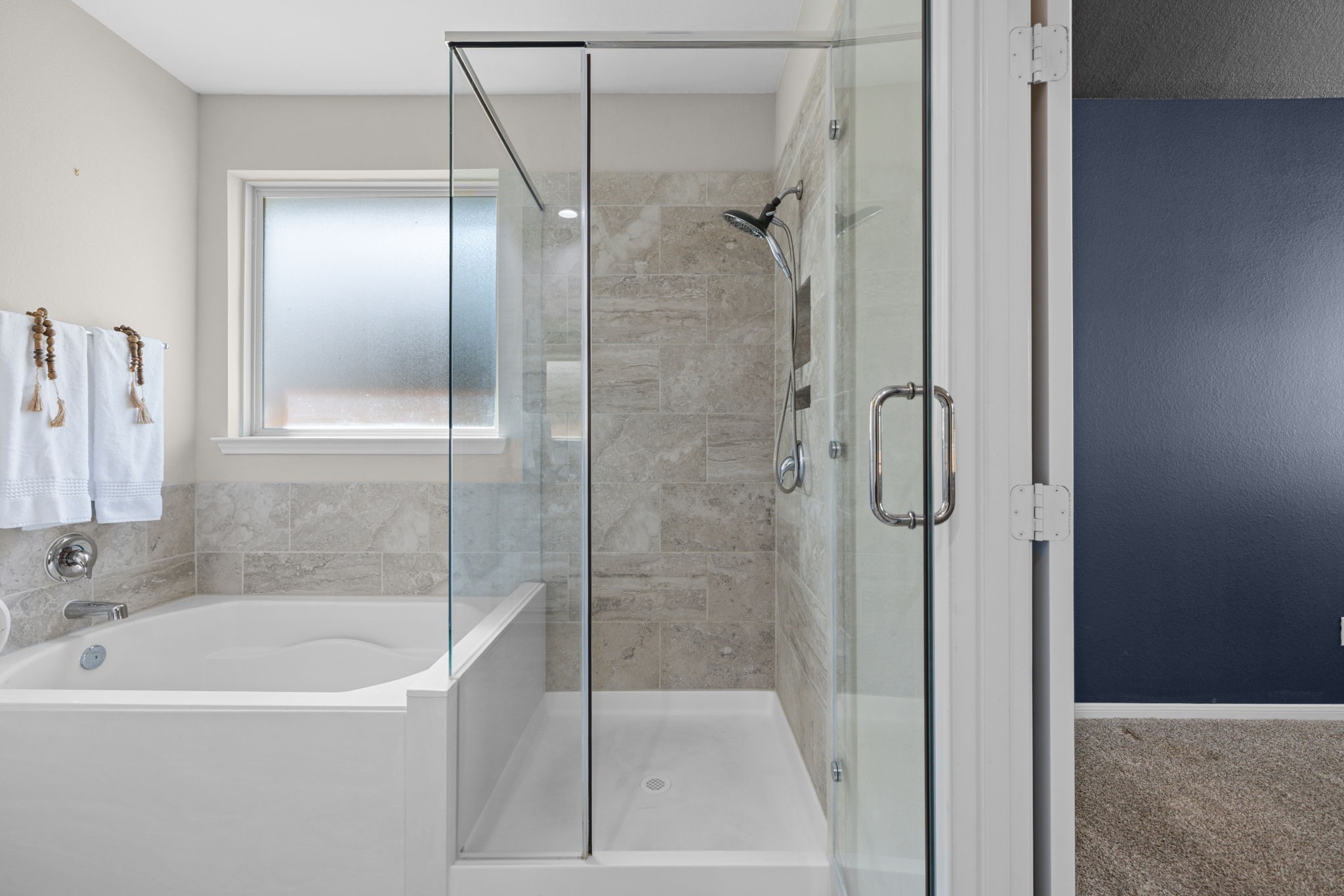 There's separate tub and walk in shower with frameless glass