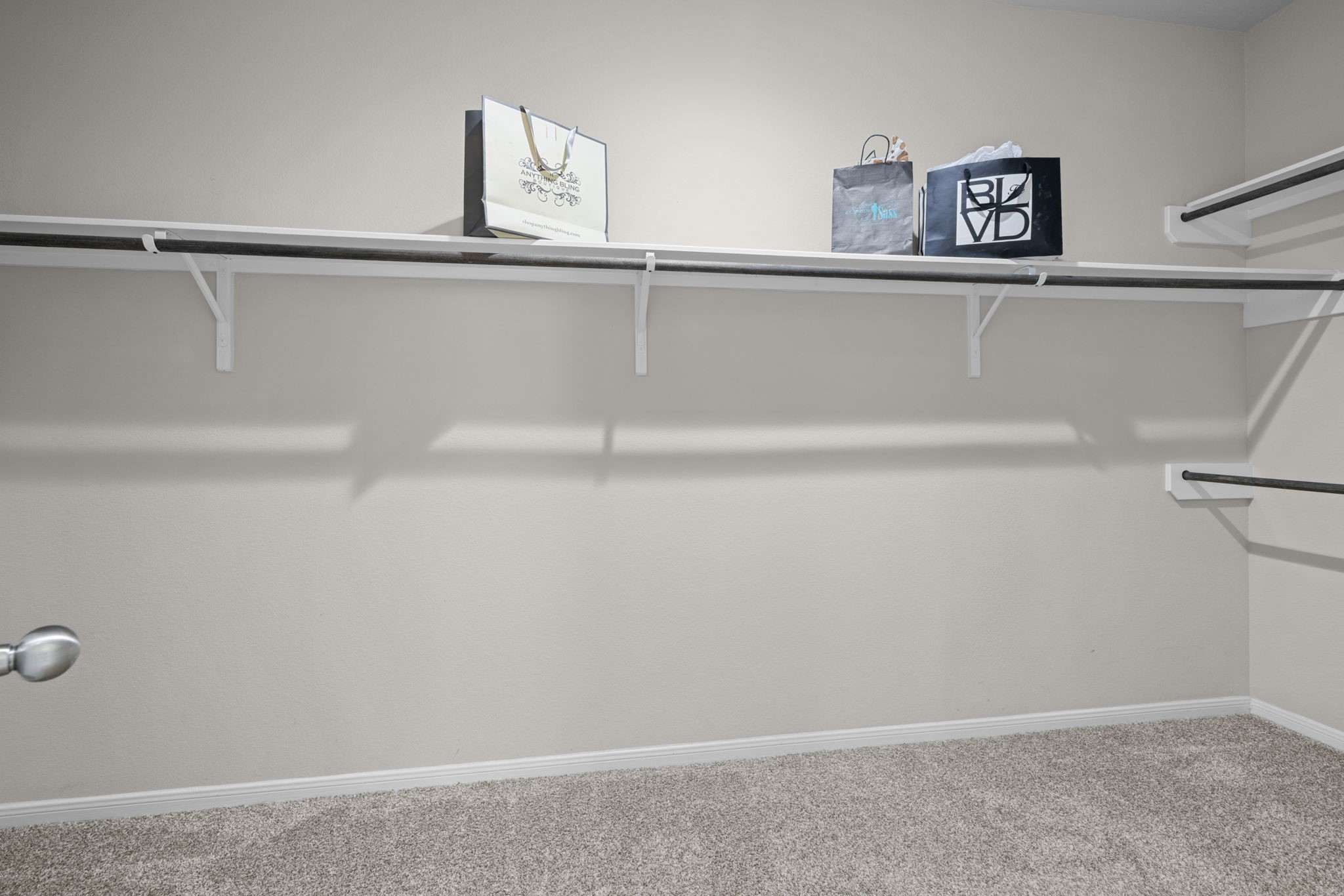 This large walk in closet offers plenty of space to hold all your items