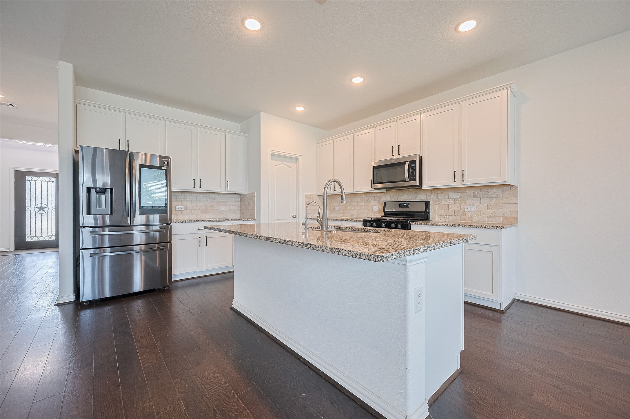 Modern kitchen features a central island.