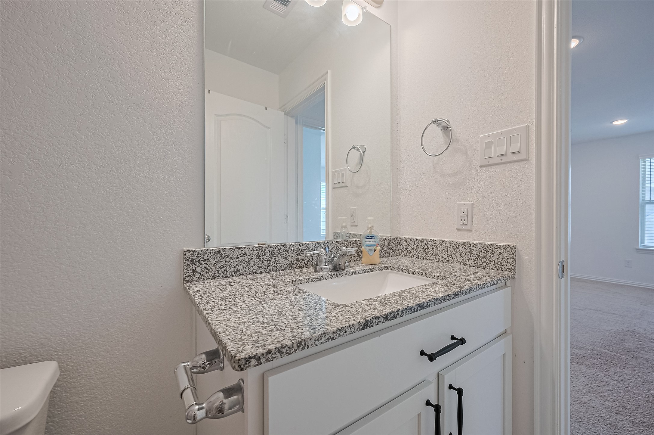 A large mirror and sleek fixtures.