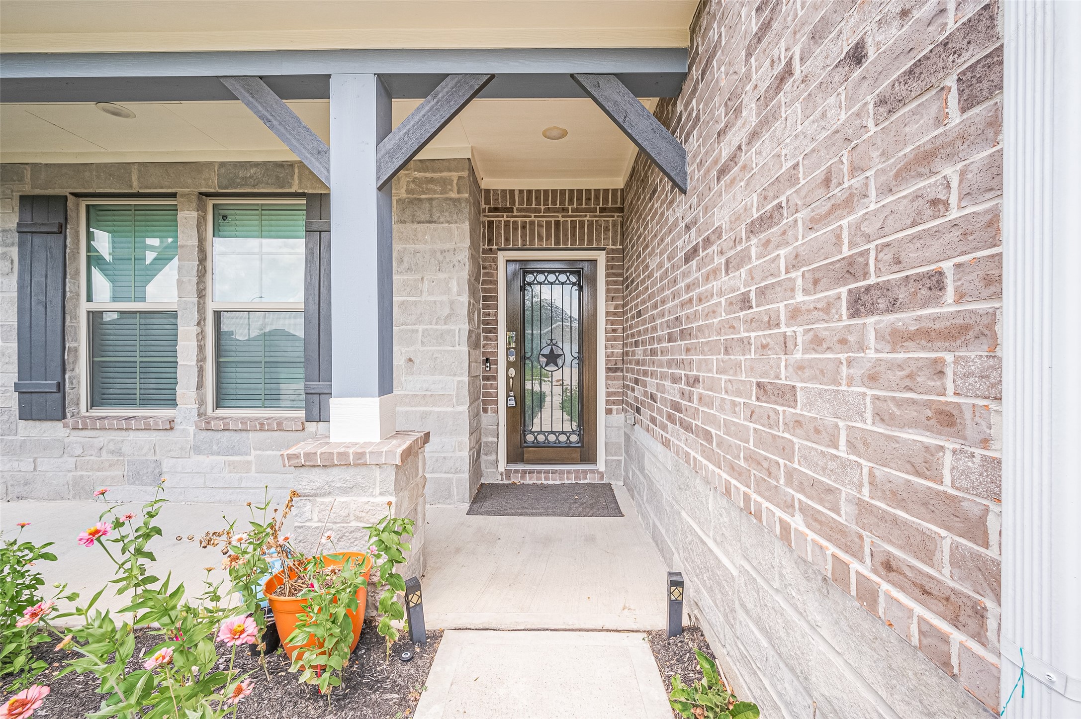 Front entrance features a brick and stone faade and decorative door with glass panels. Front entrance features a brick and stone faade and decorative door with glass panels.