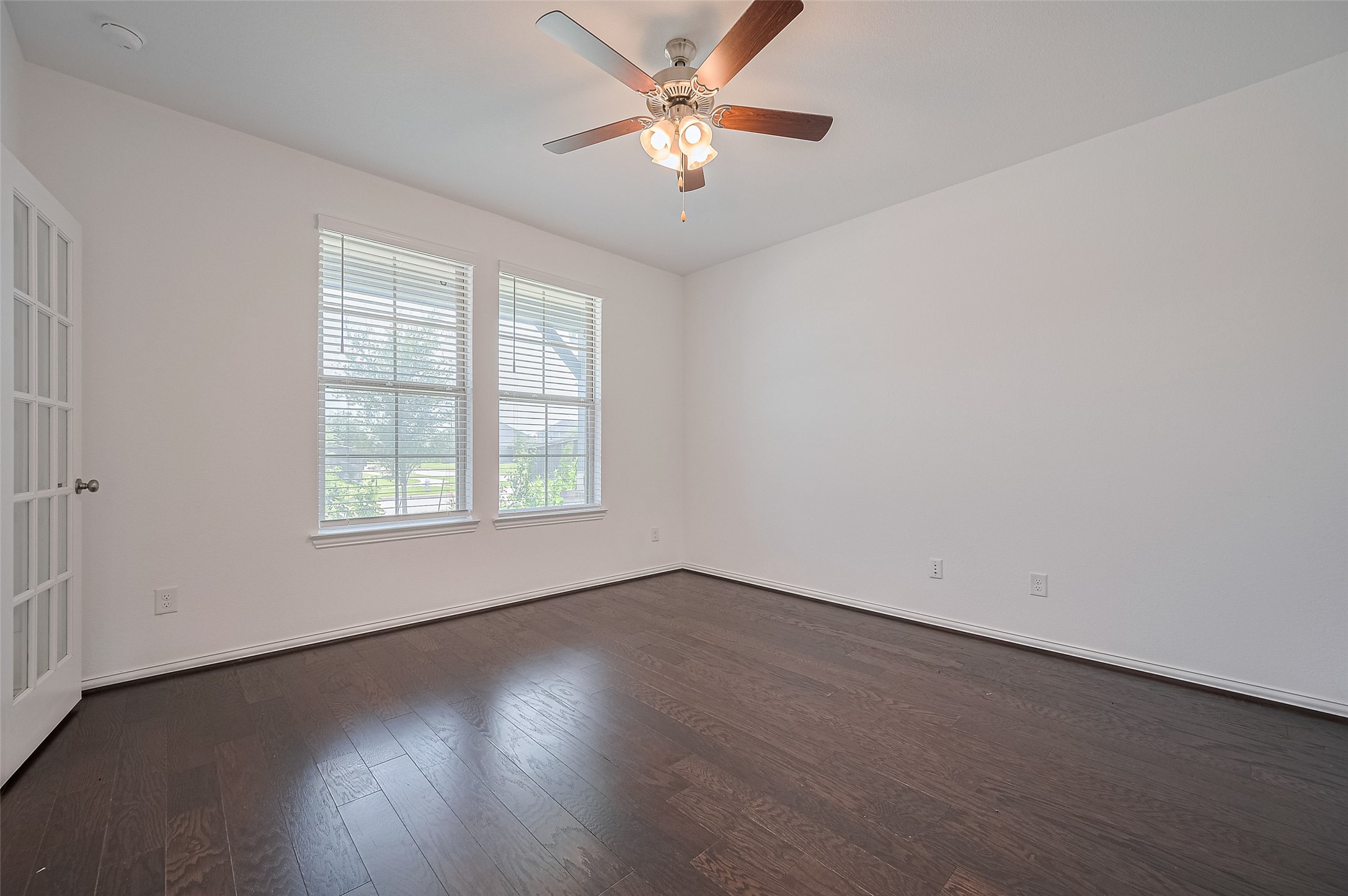 Room features fresh white walls, and a ceiling fan with lights Room features fresh white walls, and a ceiling fan with lights