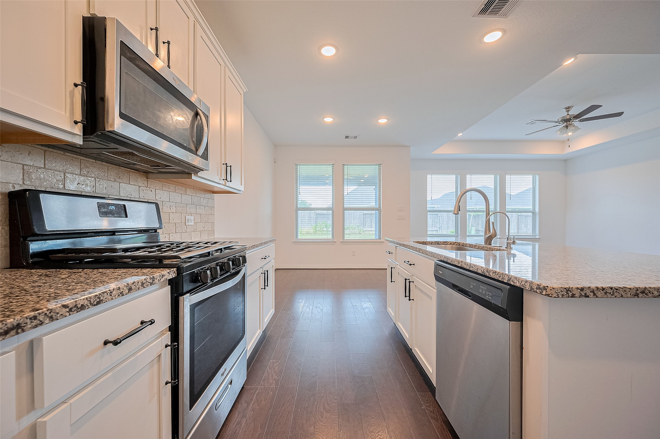 Kitchen includes a built-in sink and stainless steel appliances.