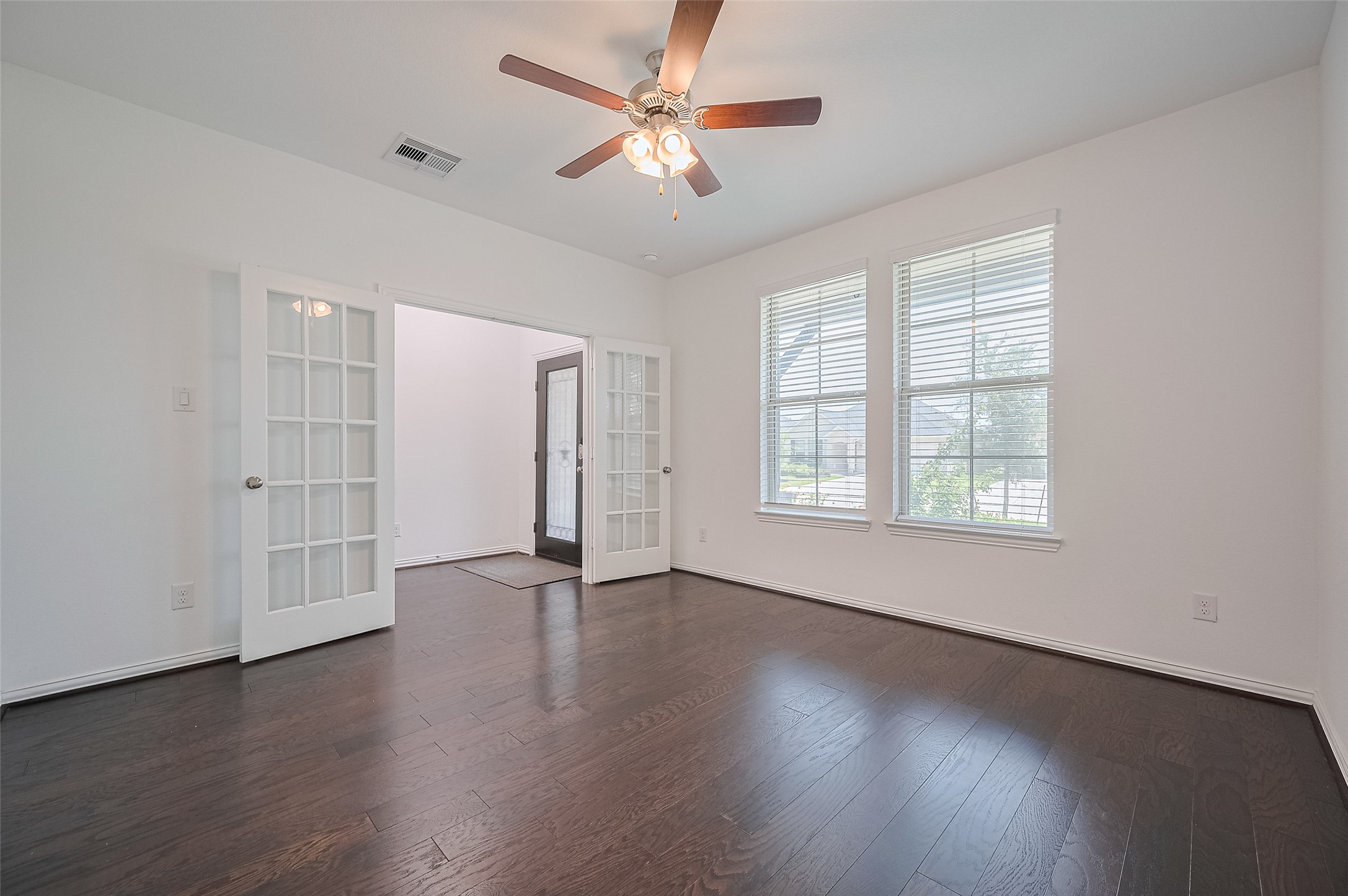 Elegant dark hardwood floors, large windows, and stylish French door. Elegant dark hardwood floors, large windows, and stylish French door.