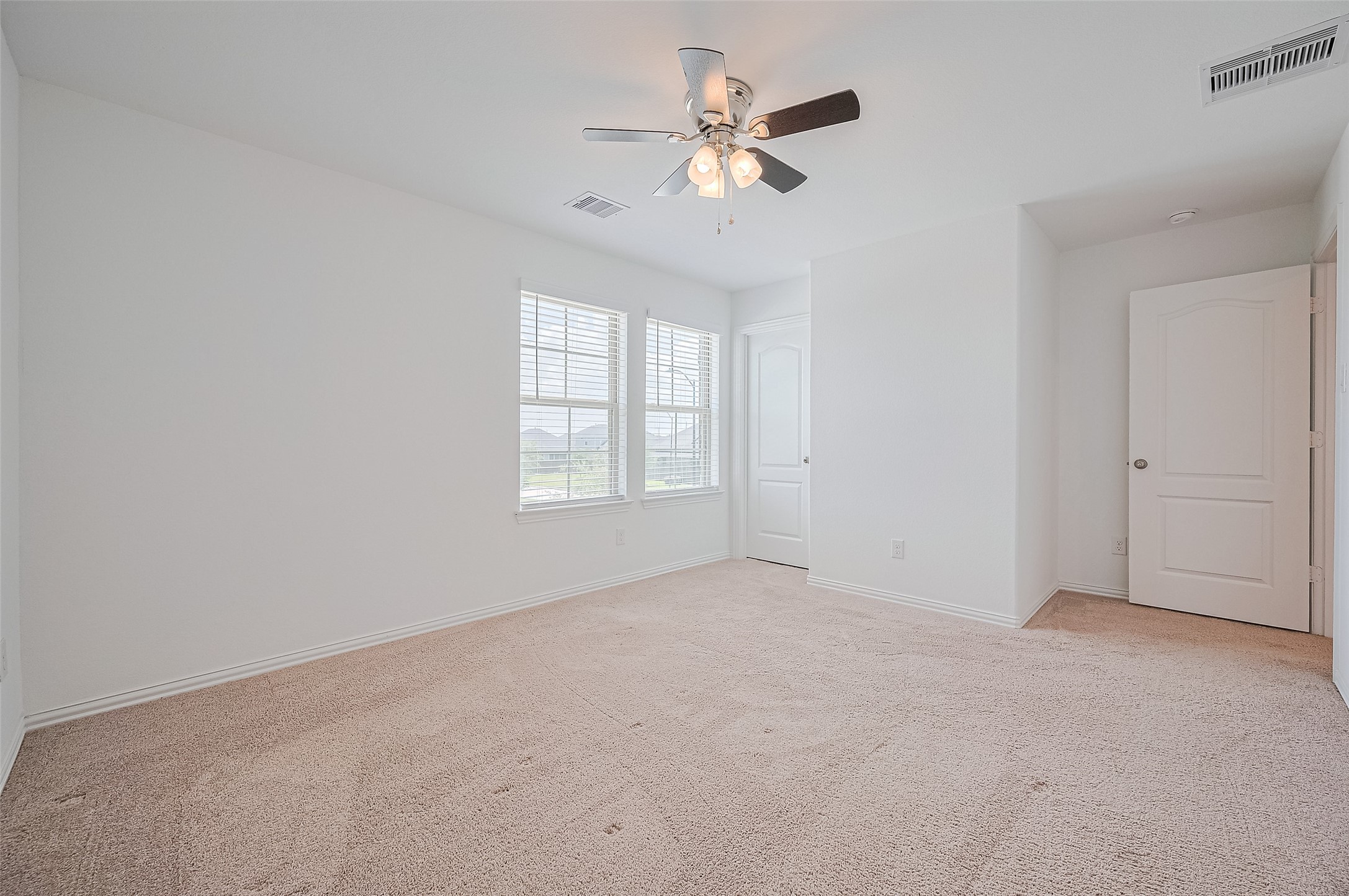 Features a closet with a white door, perfect for a cozy and inviting space.