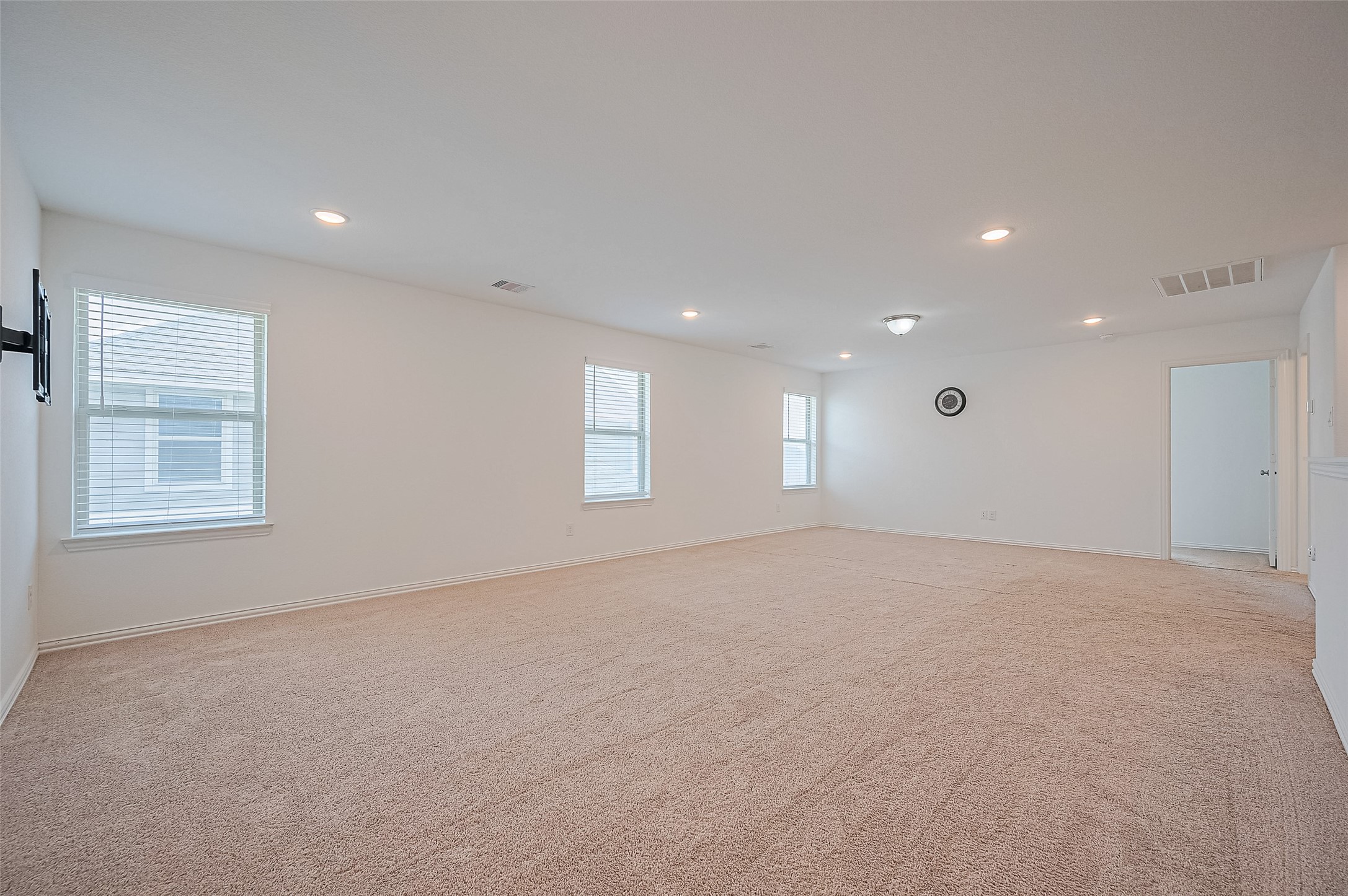 It includes multiple doors and a half-wall, offering a versatile layout.