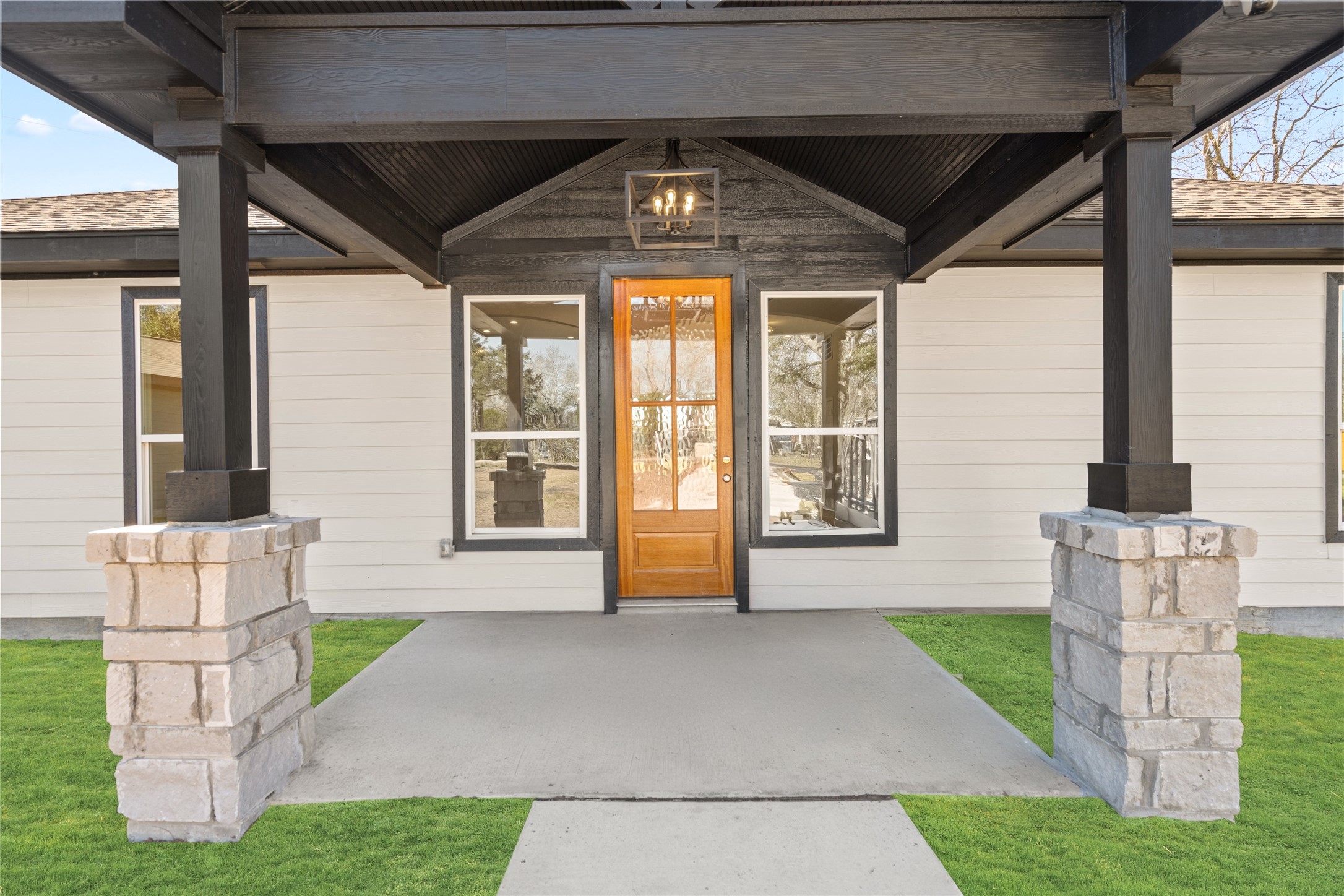 The front porch framed by
elegant pillars exudes charm
and sophistication, perfectly
complementing the homes
clean architectural lines.