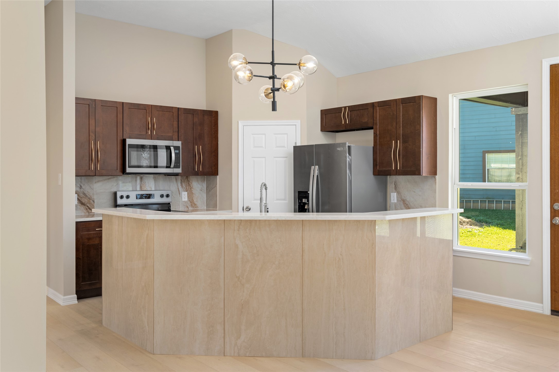 The heart of the home shines
with a spacious island,
modern lighting, and
expansive countertops,
perfect for culinary creations
or casual dining.