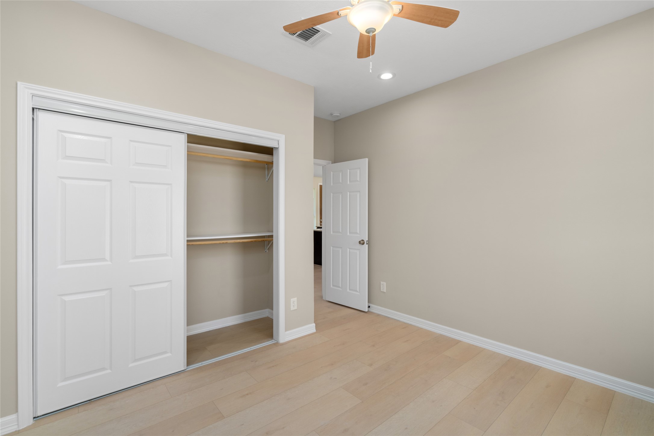 Spacious bedroom with generous closet space and a clean, modern palette. A perfect canvas for any style.