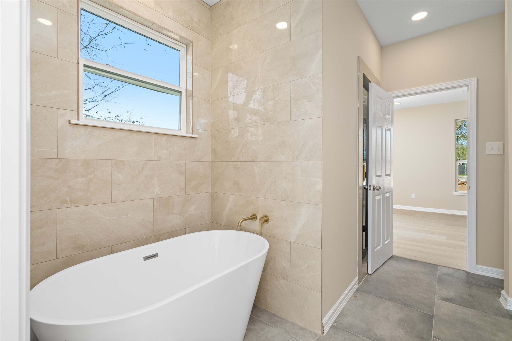 Stunning freestanding tub
framed by sleek tile work
perfect for relaxing evenings.
Bright, airy design
complements modern
finishes.