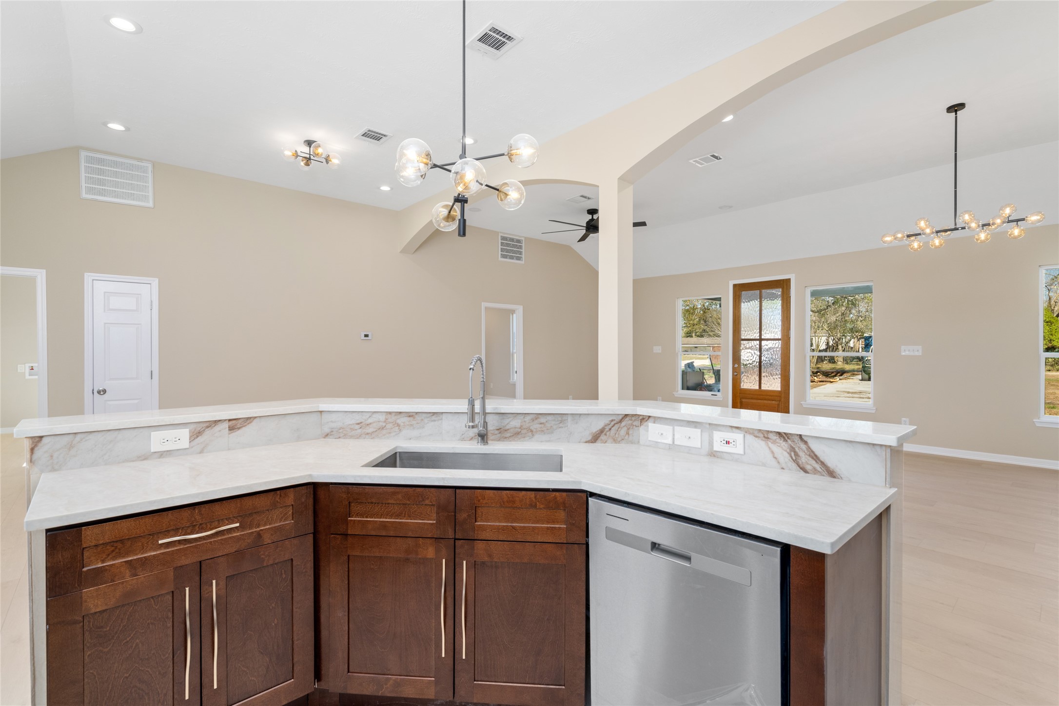 From this angle, the kitchen
island shines as the
centerpiece, ideal for meal
prep, casual dining, or
gathering with loved ones