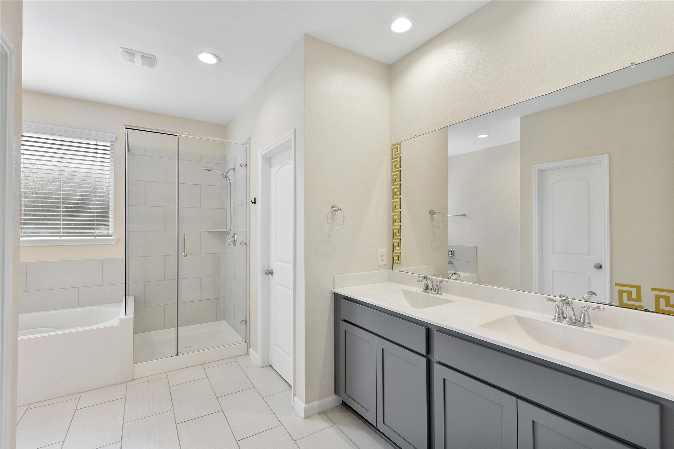 Primary bath with double sinks and separate tub and shower