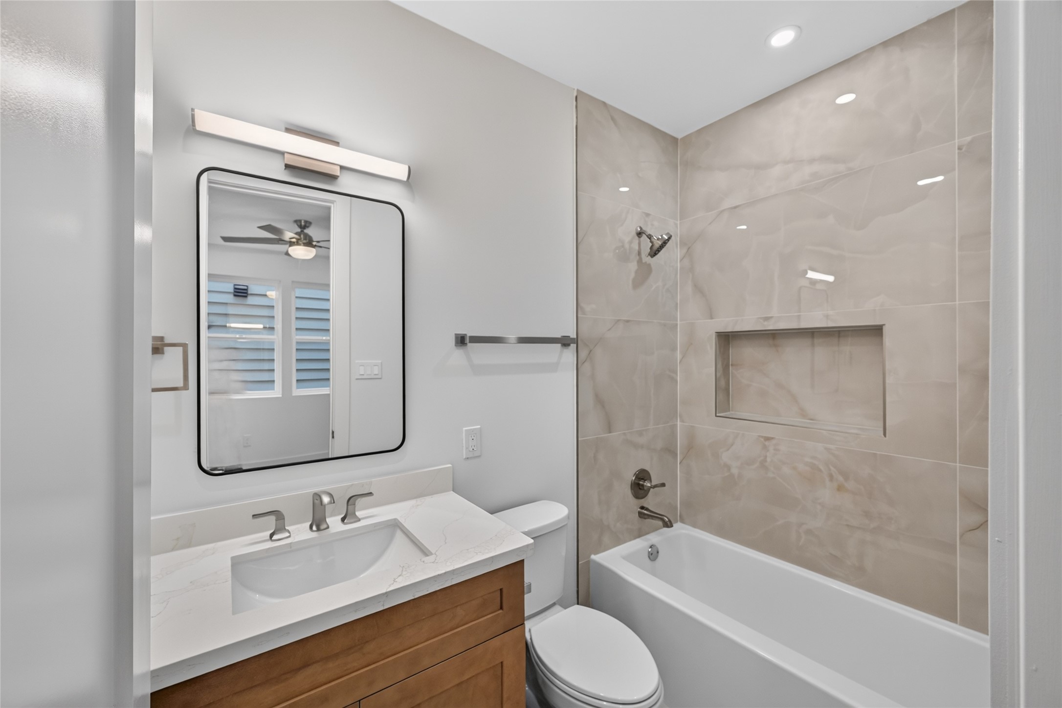 secondary Bathroom located in the bedroom by the entry way. featuring beautiful tile that extends to the ceiling