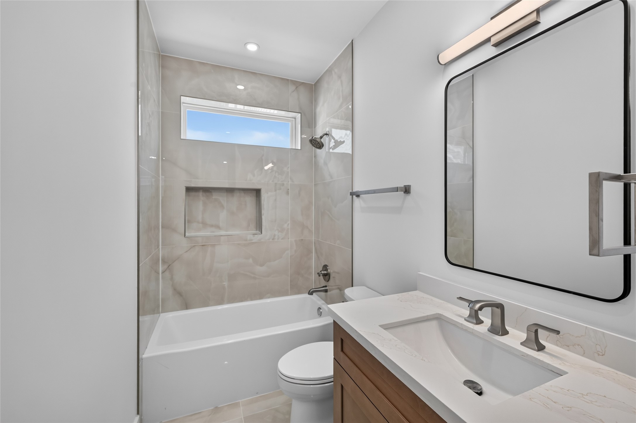 Secondary bathroom located on the third floor with beautiful tile extended to the ceiling