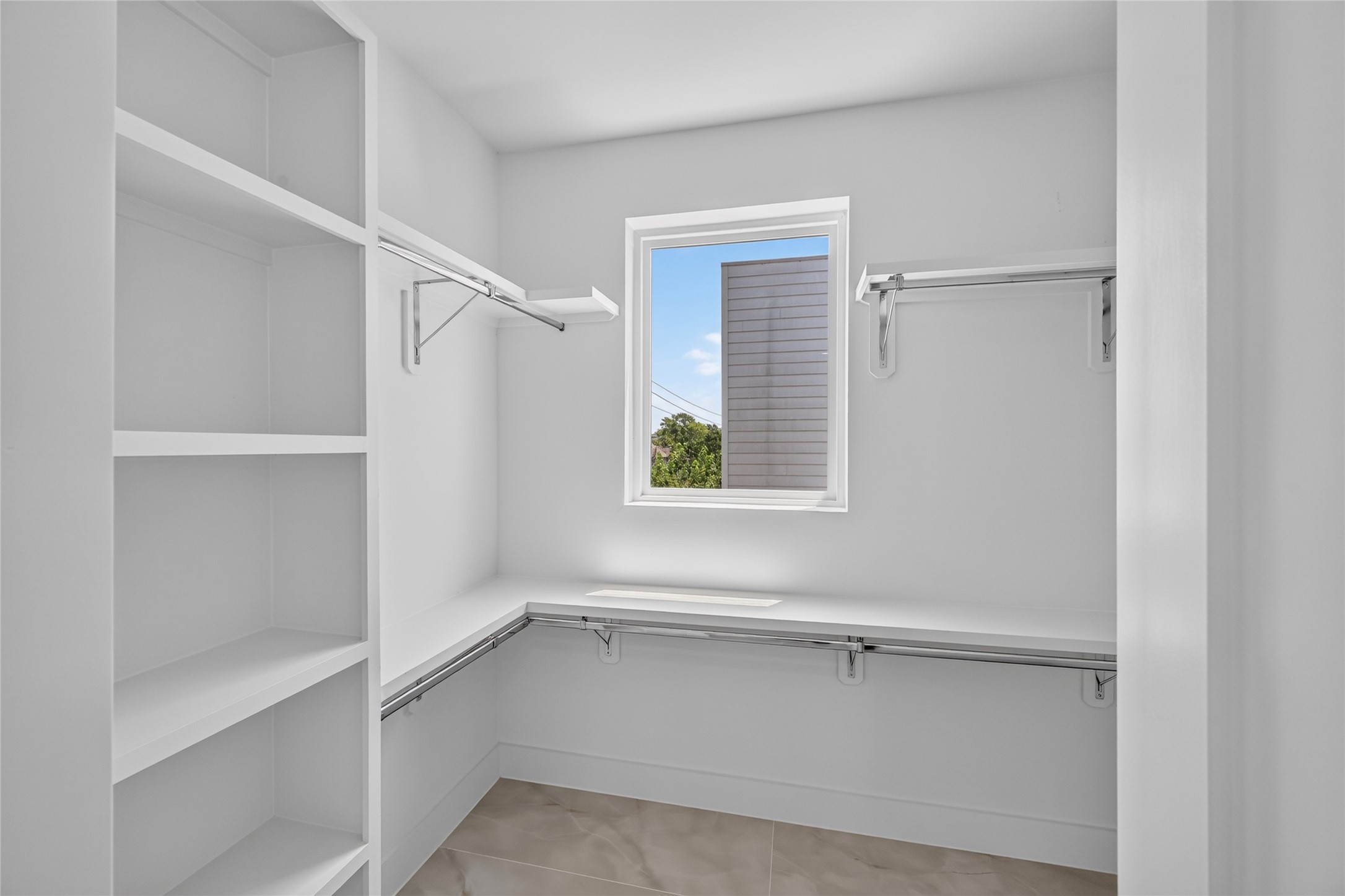 Primary closet with custom shelves and steel rods for durability