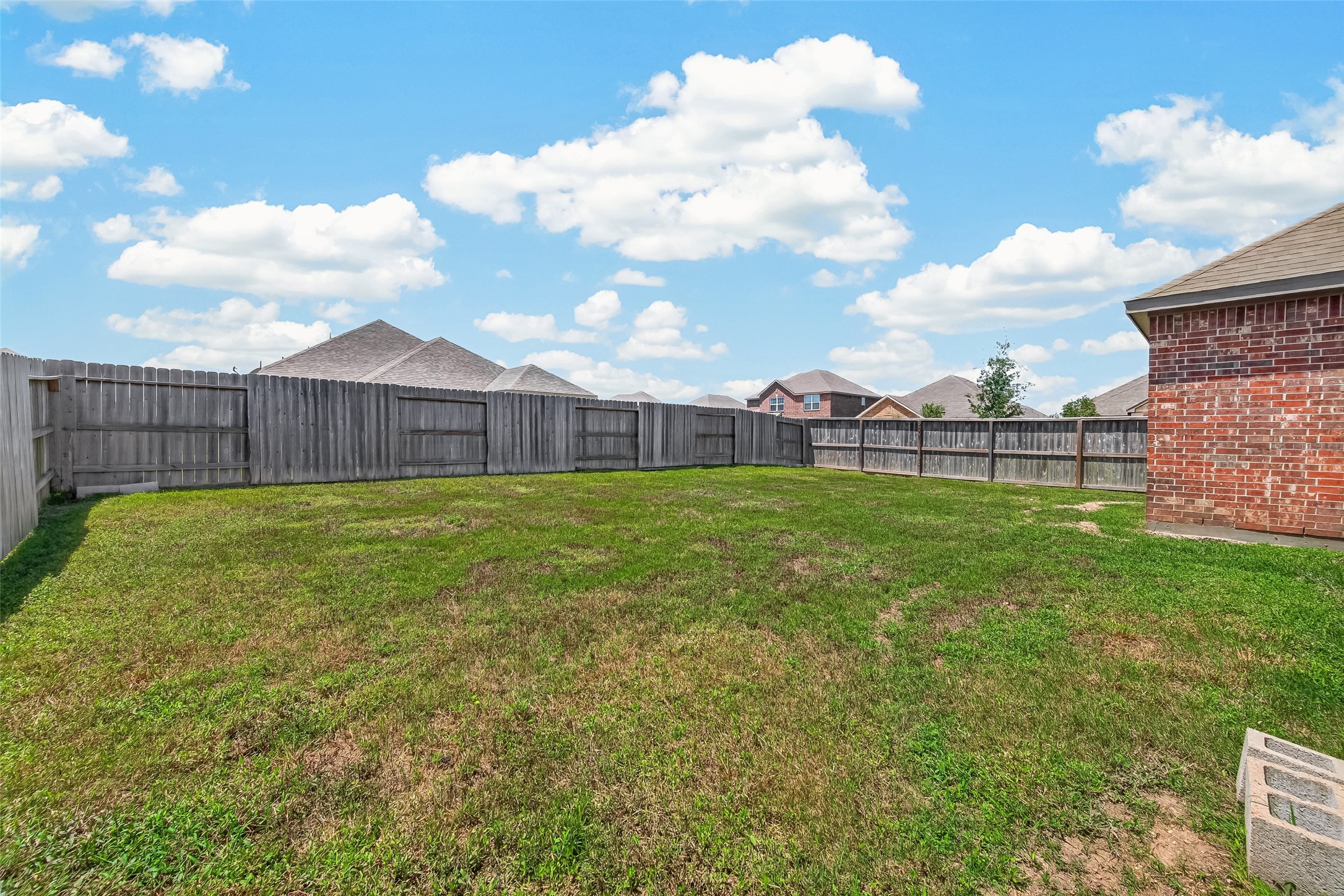 Large fenced backyard.