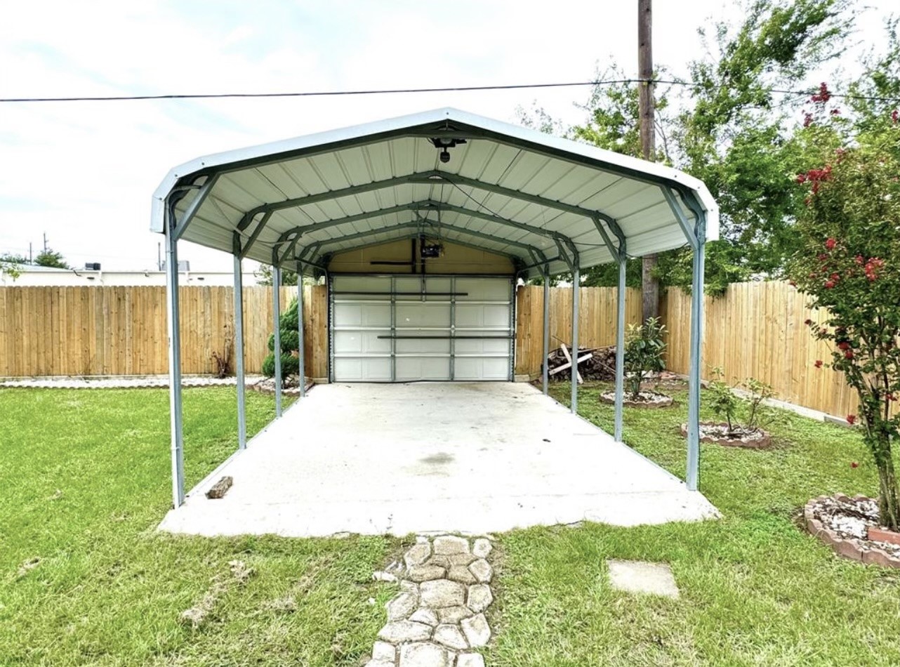 There is also a covered driveway with a garage door ini the backyard which is connected to the parking lot behind the home.