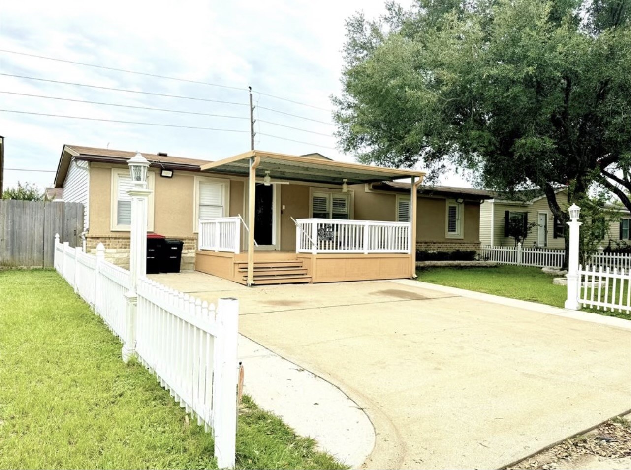 Entrance of the home includes a long driveway along with a covered patio in the front.