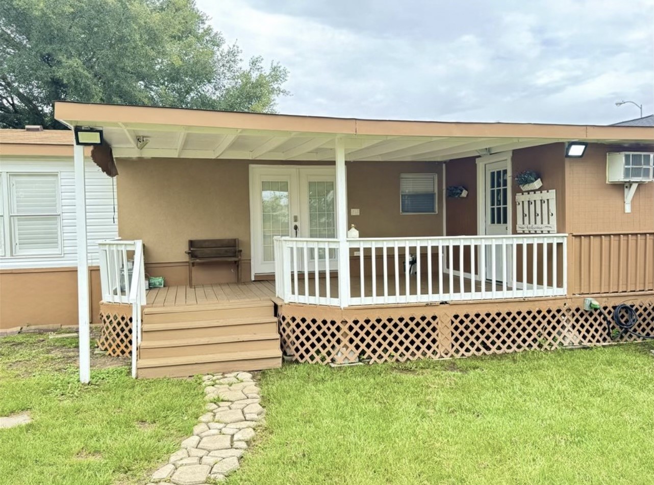 Backyard includes a large covered patio.