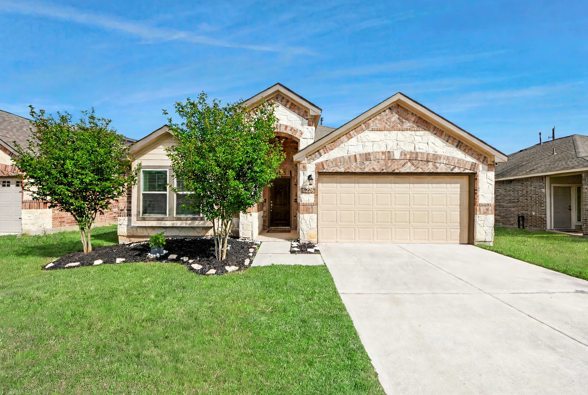 Front view of home showing brick and stone elevation