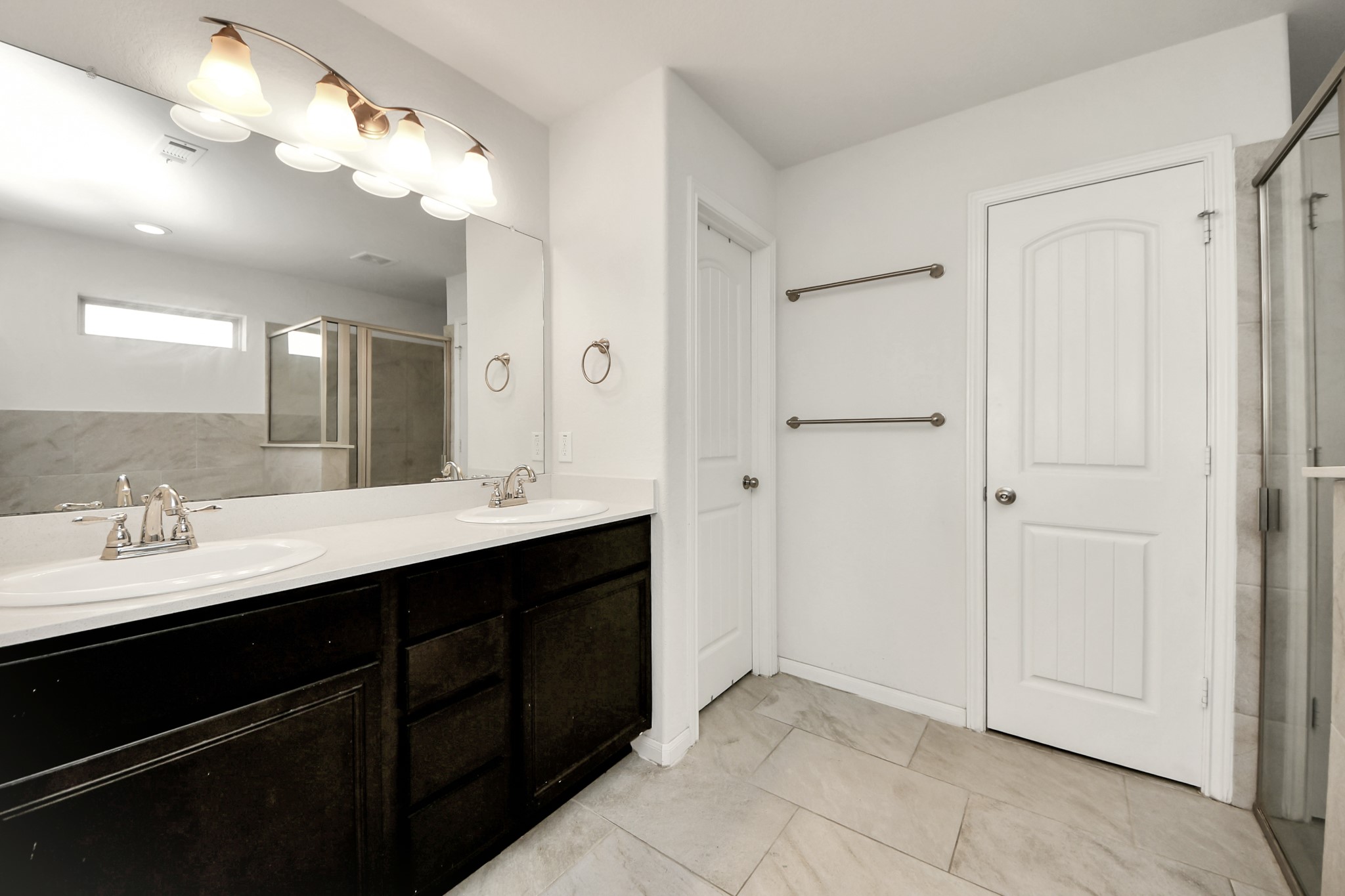Primary restroom with access to laundry room through the closet door here