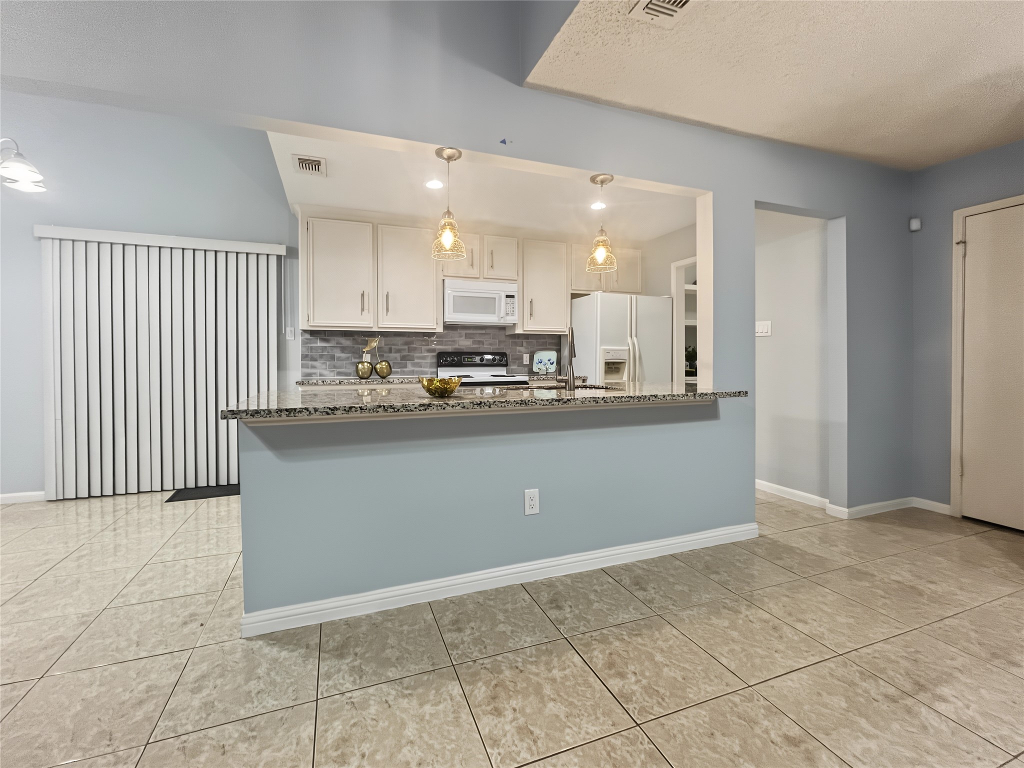 View of the kitchen from the living and social areas.