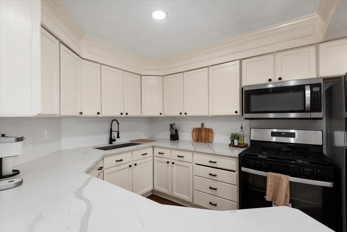 Downstairs Kitchen features abundant cabinetry and counter space.