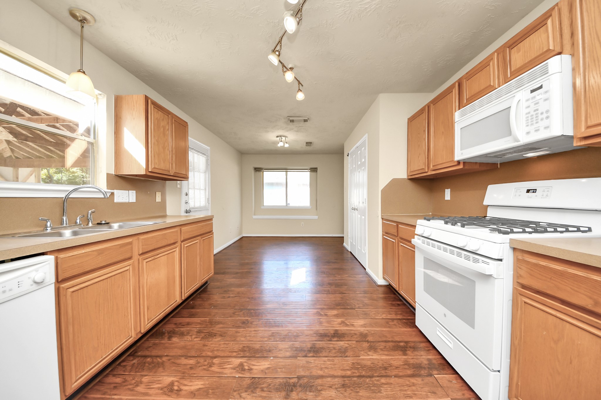 Spacious kitchen with hardwood floors, plenty of natural light, and a cozy breakfast nook.