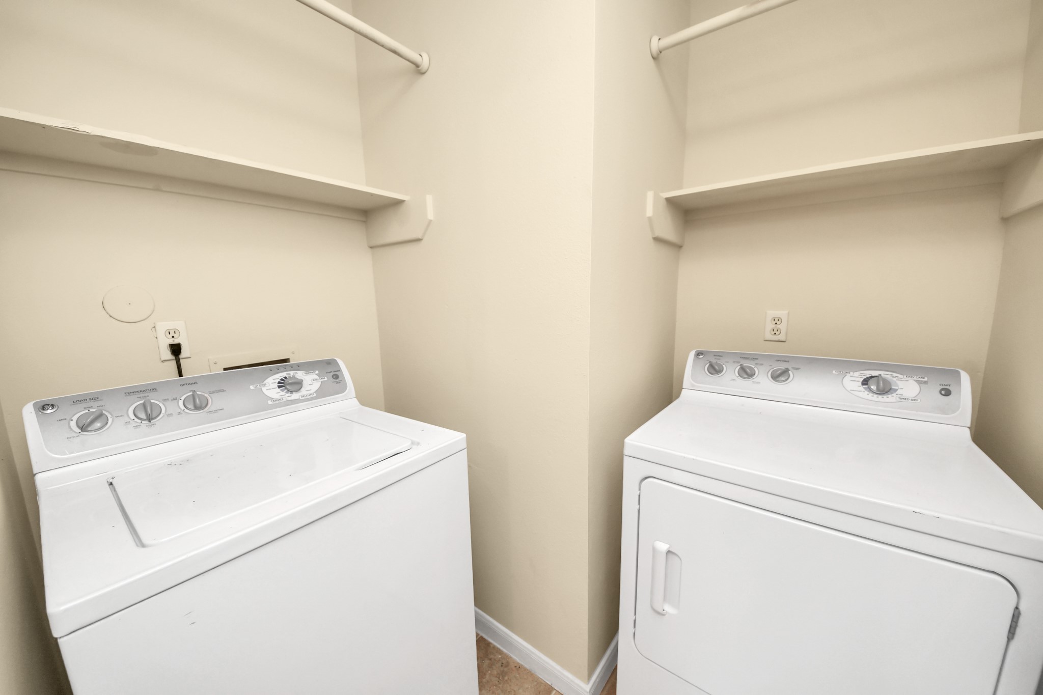Laundry room with washer and dryer included and plenty of storage for easy organization.