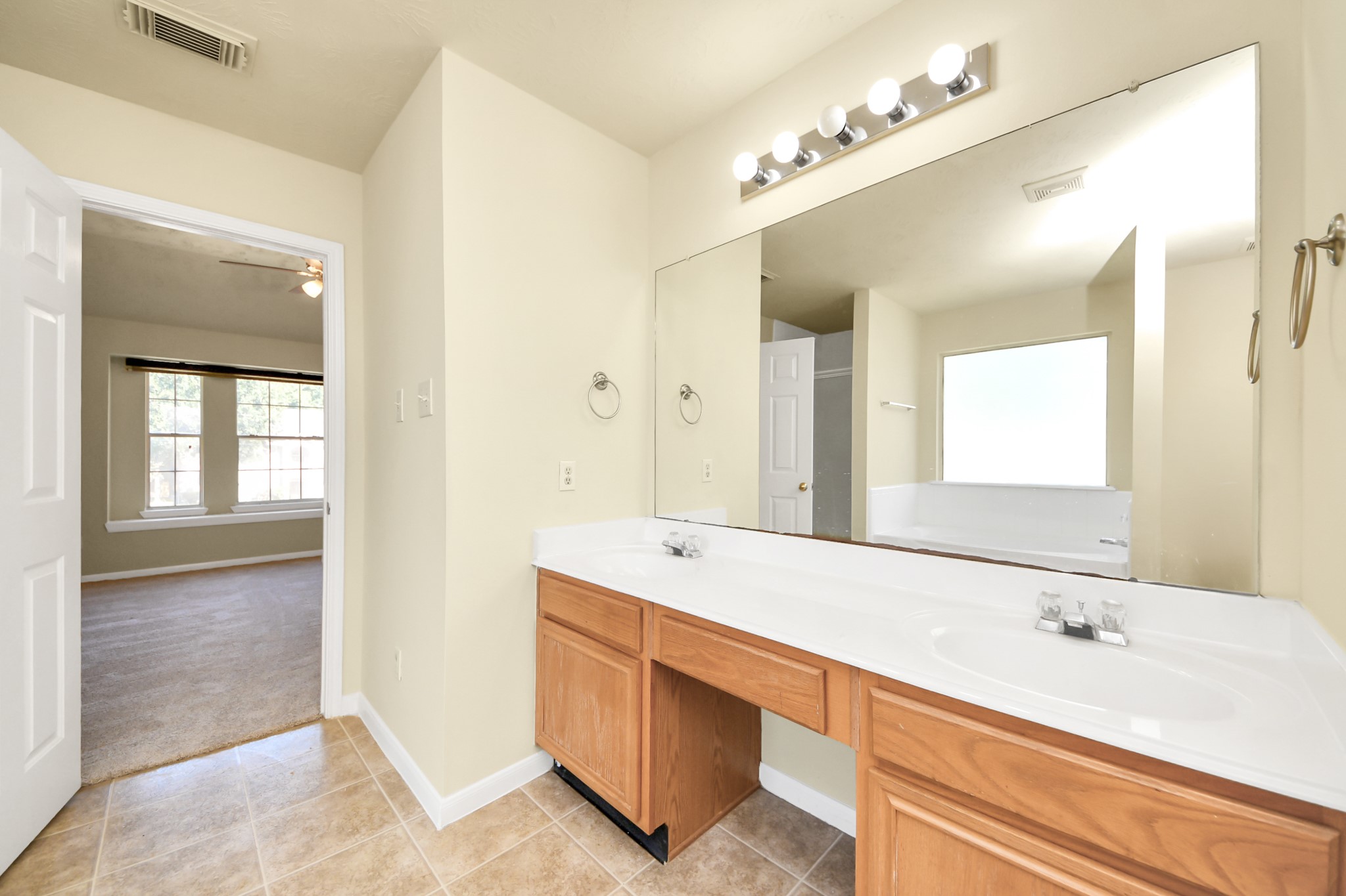 Dual sinks in this large primary bathroom.