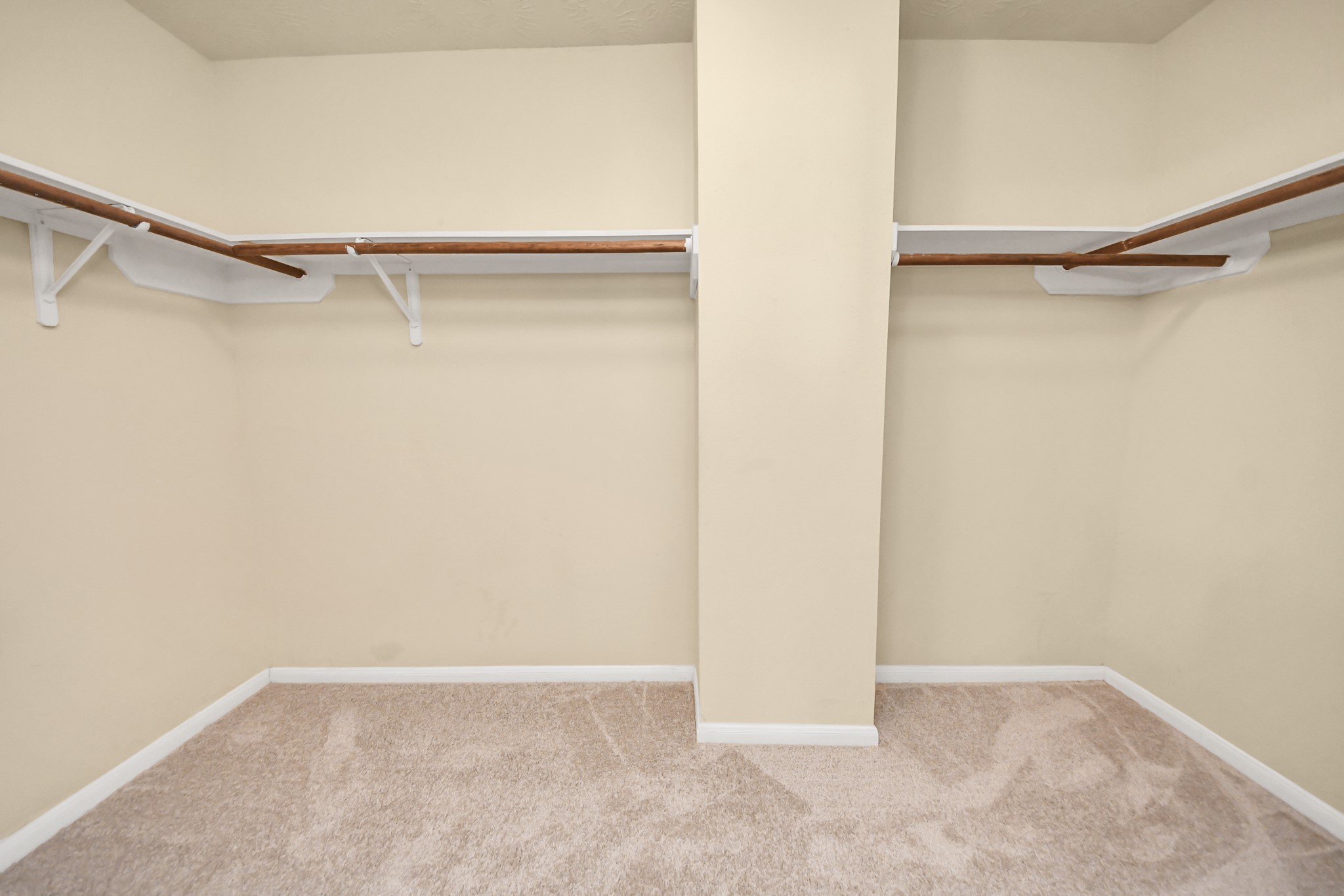 Walk-in closet with ample shelving and hanging space, perfect for organizing your wardrobe.
