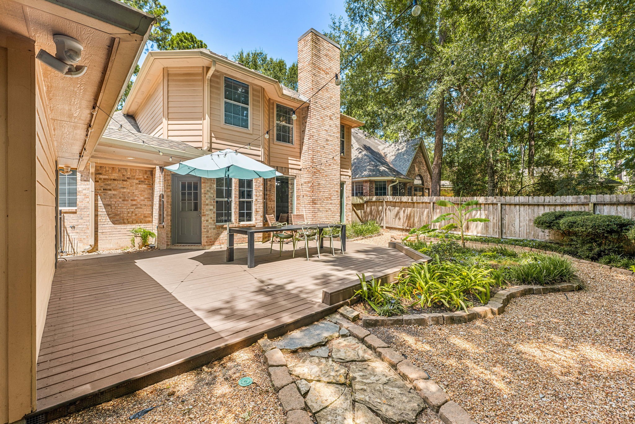 Charming outdoor deck features a spacious seating area. perfect for entertaining. Surrounded by lush greenery and a cozy atmosphere, it offers a seamless blend of comfort and style.