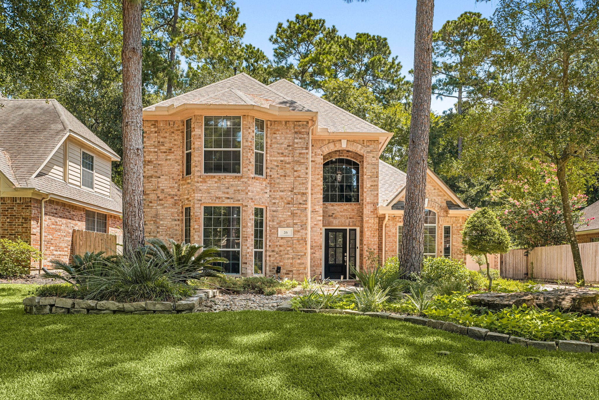 Stunning two-story brick home nestled among mature trees, featuring elegant arched windows and lush landscaping for great curb appeal. Stunning two-story brick home nestled among mature trees, featuring elegant arched windows and lush landscaping for great curb appeal.