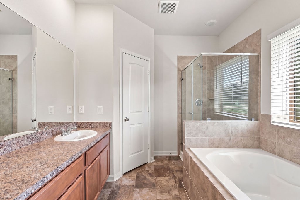 Primary bathroom tub, shower.