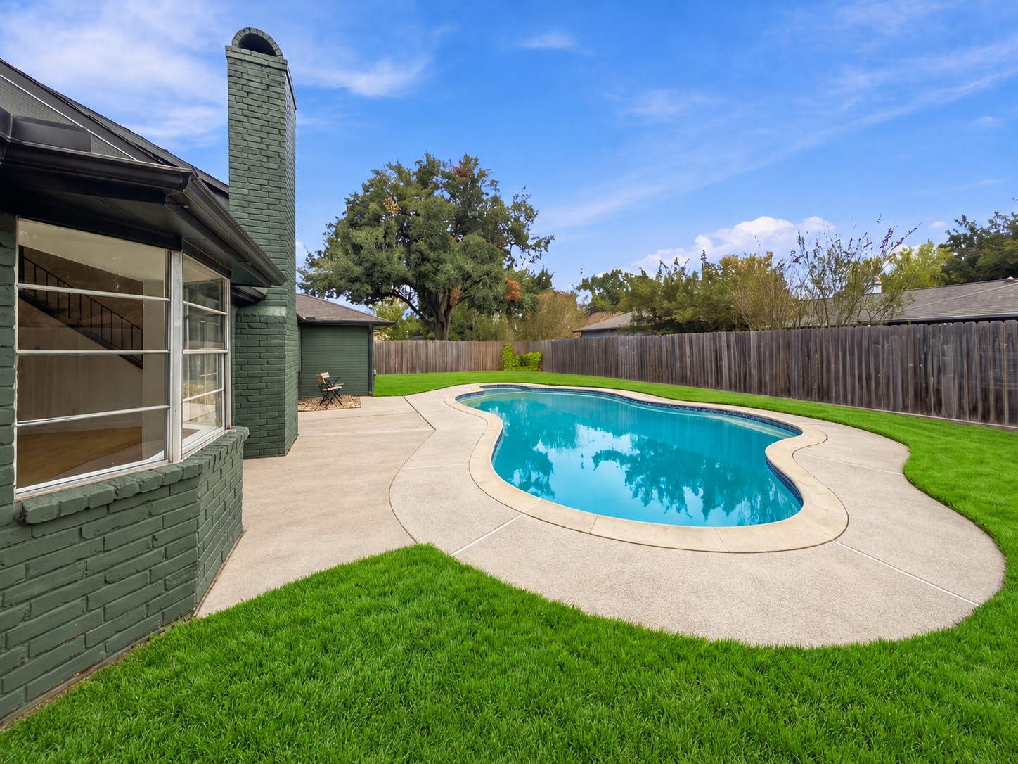 Enjoy the spacious backyard and beautifully refreshed swimming pool.