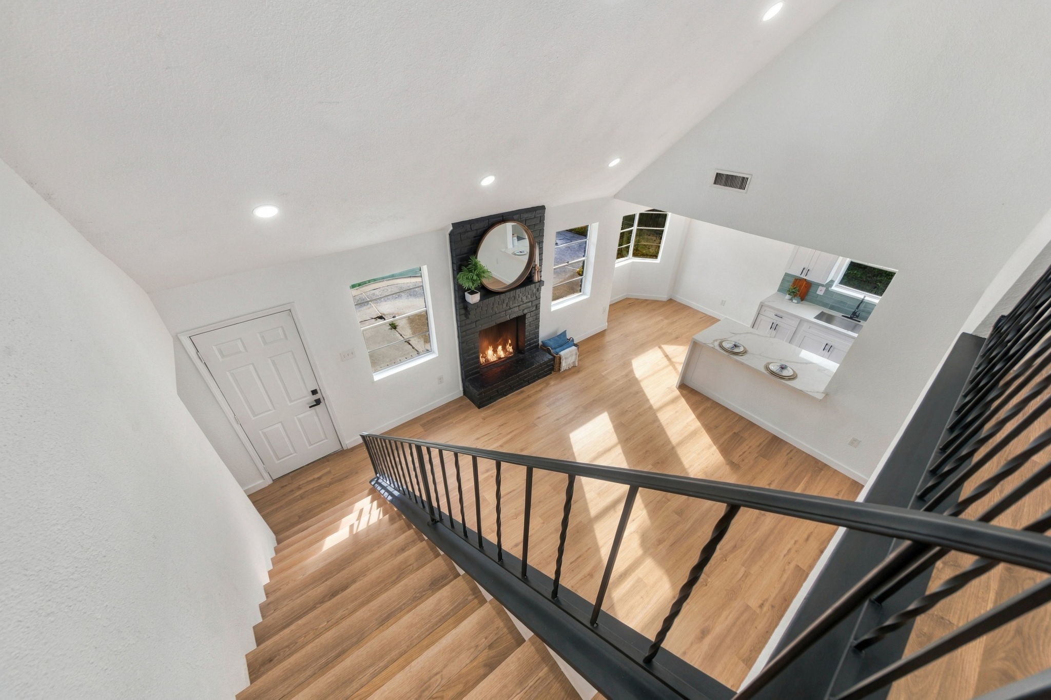 A view overlooking the bright and welcoming living room with seamless flow into the kitchen.