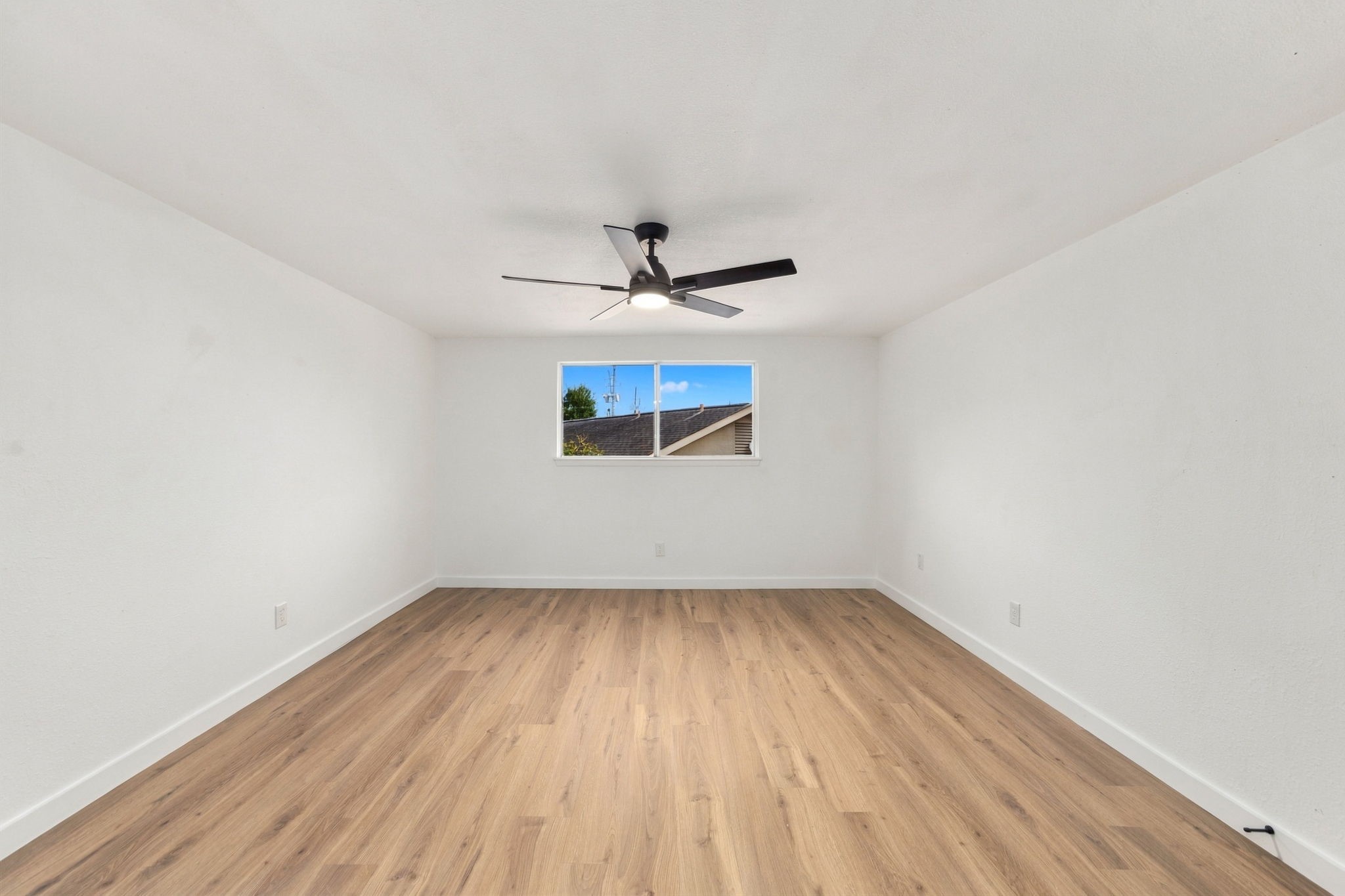 Upstairs bedroom with luxury vinyl plank flooring and updated ceiling fan.