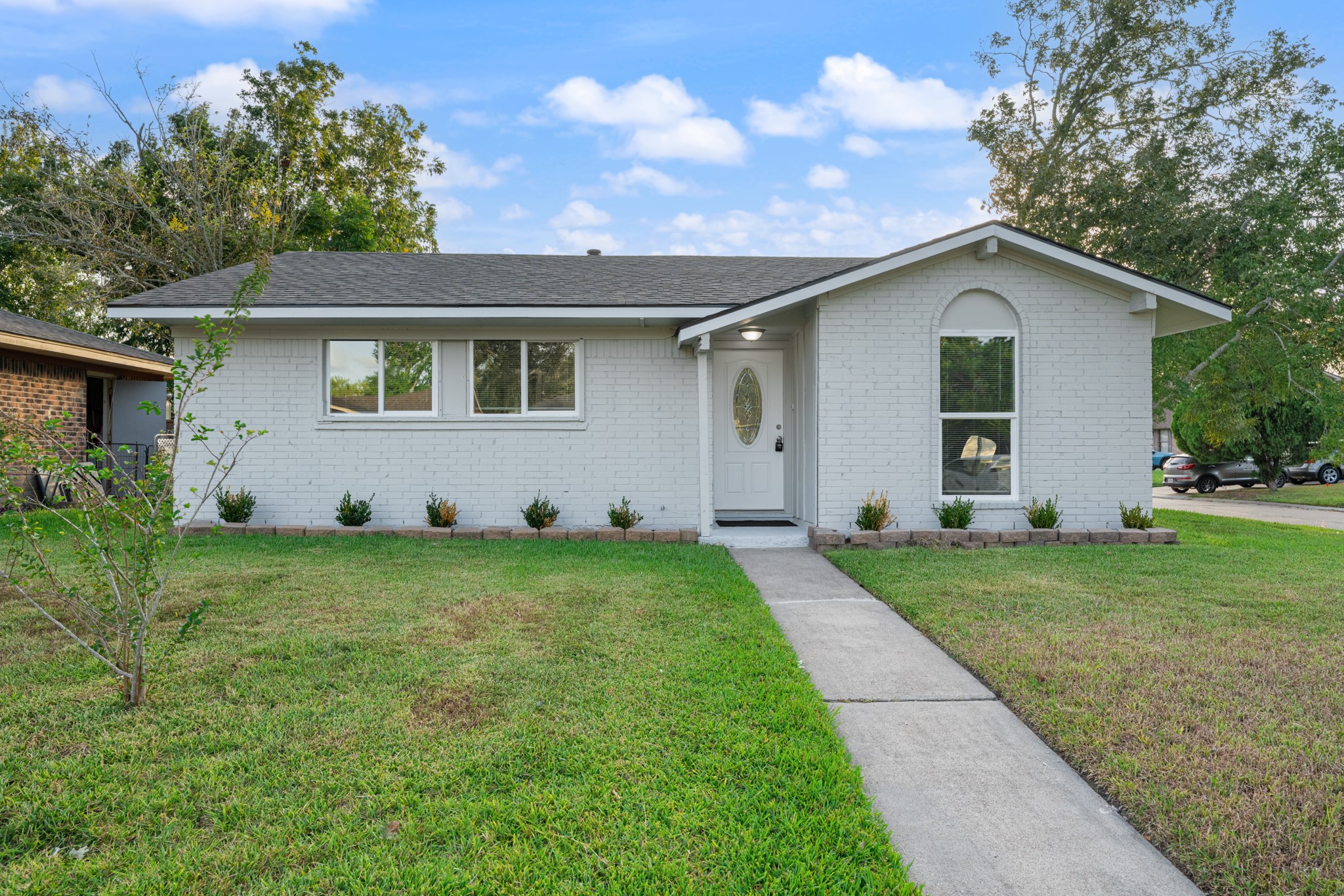 Charming single-story home featuring a freshly updated painted brick exterior, welcoming covered entry, and distinctive arched window detail. A neatly landscaped front yard and walkway complete the inviting curb appeal. Charming single-story home featuring a freshly updated painted brick exterior, welcoming covered entry, and distinctive arched window detail. A neatly landscaped front yard and walkway complete the inviting curb appeal.